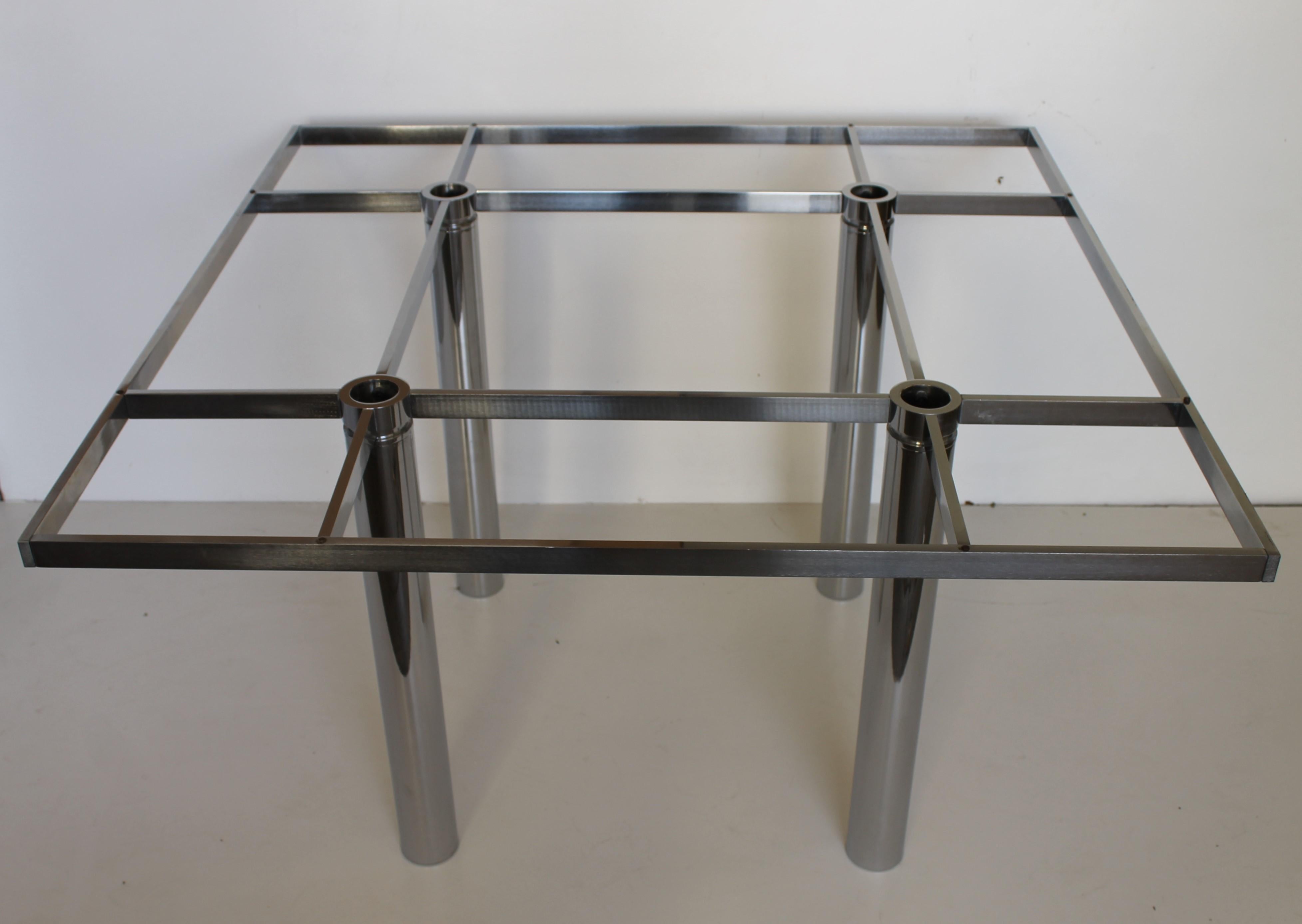 Andre square dining table designed by Tobia Scarpa for Gavina, dated 1968.

Smoked glass top on chrome structure.

 