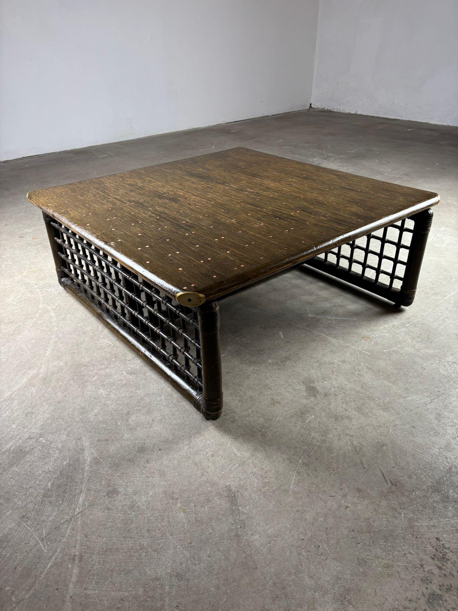 Coffee table designed by Tobia Scarpa, crafted in bamboo with a top made of bamboo canes secured with copper nails, showcasing meticulous attention to detail and artisanal craftsmanship. Produced by B&B Compagnia delle Filippine, the table measures