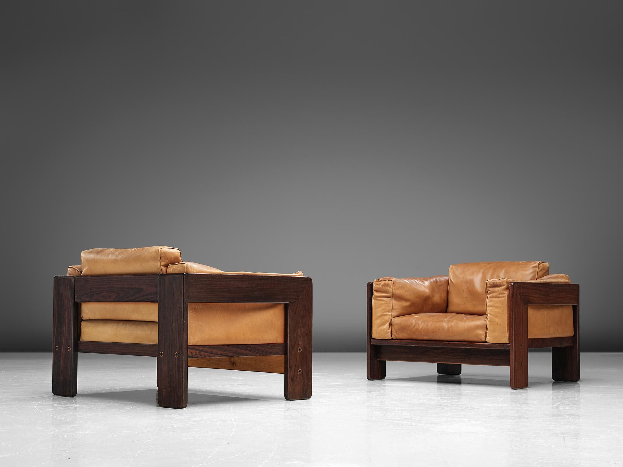 Tobia Scarpa for Knoll, pair of 'Bastiano' club chairs, leather and rosewood, Italy, design 1960, manufactured in 1970s.

Beautiful pair of Bastiano club chairs made with a rosewood frame and brown leather cushions. Tobia Scarpa designed the