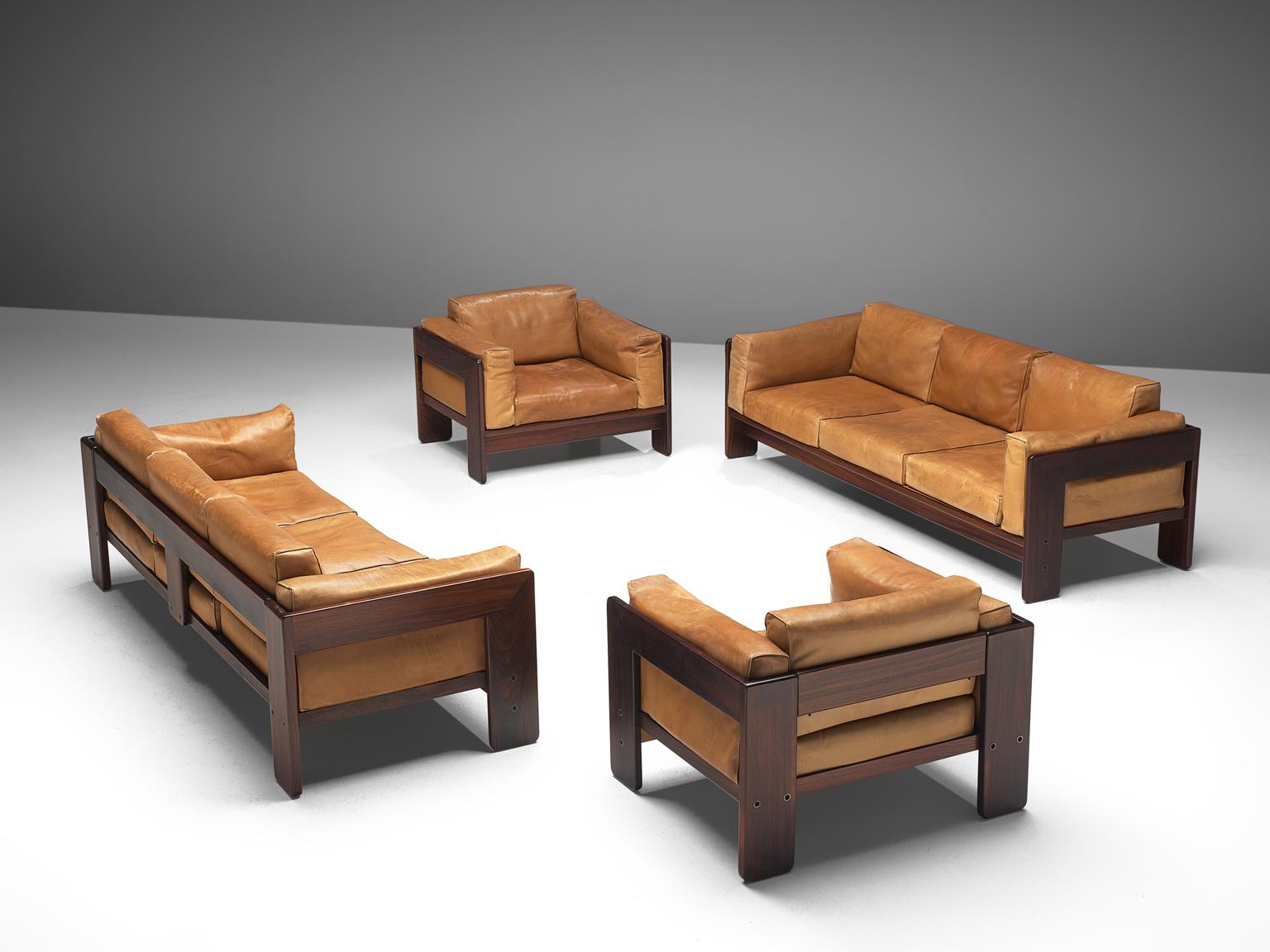 Tobia Scarpa for Knoll, 'Bastiano' lounge set, leather and rosewood, Italy, design 1960, manufactured between 1969-1970s.

Beautiful set of Bastiano club chairs and sofas made with a rosewood frame and cognac leather cushions. Tobia Scarpa