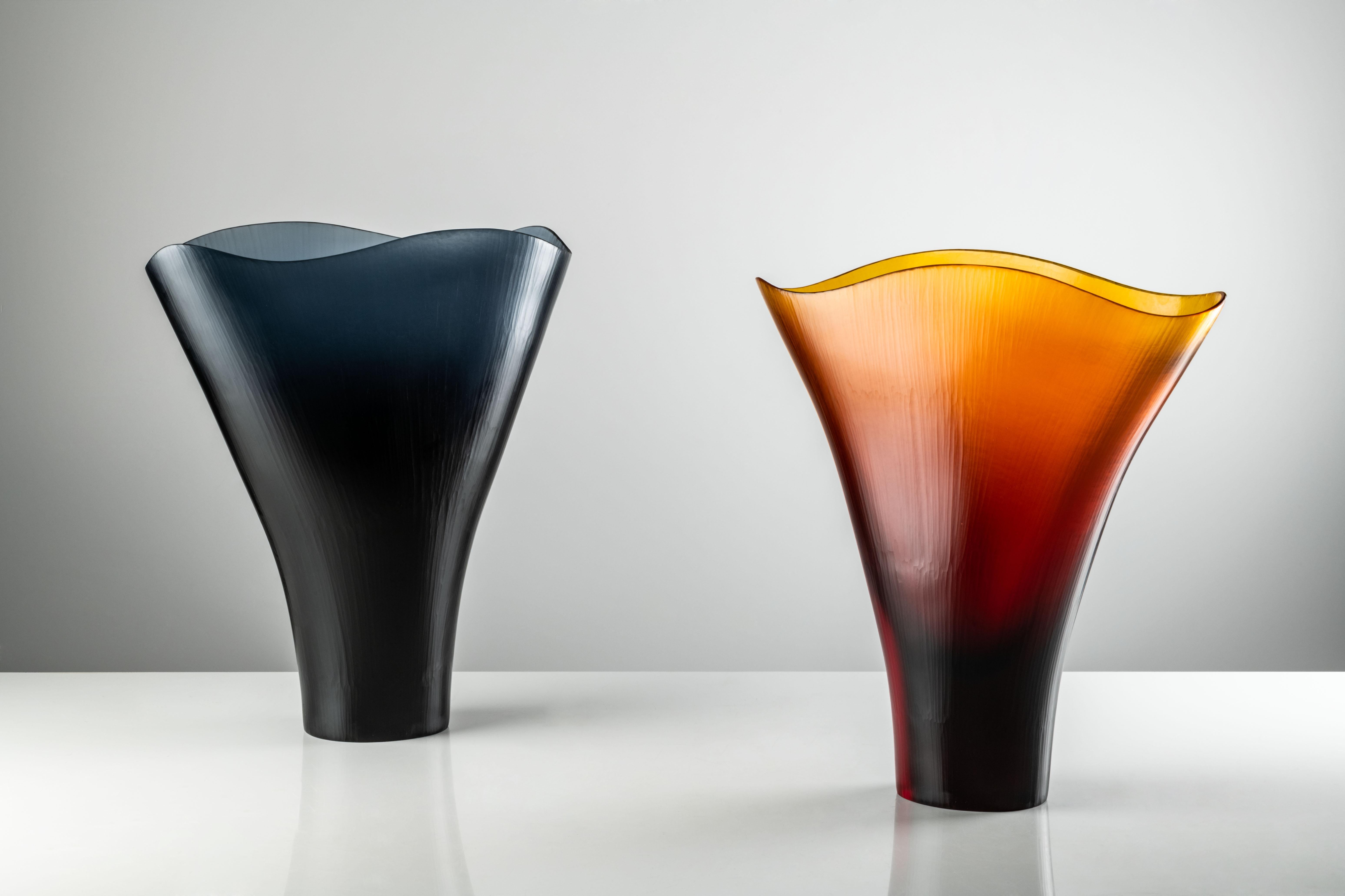 Battuti vase in Amber Murano glass by Tobia Scarpa and Ludovico Diaz De Santillana for Venini. It evokes a lily standing tall, in tones of Amber and Grape. Its translucent appearance is the result of the skill and hard work of the master