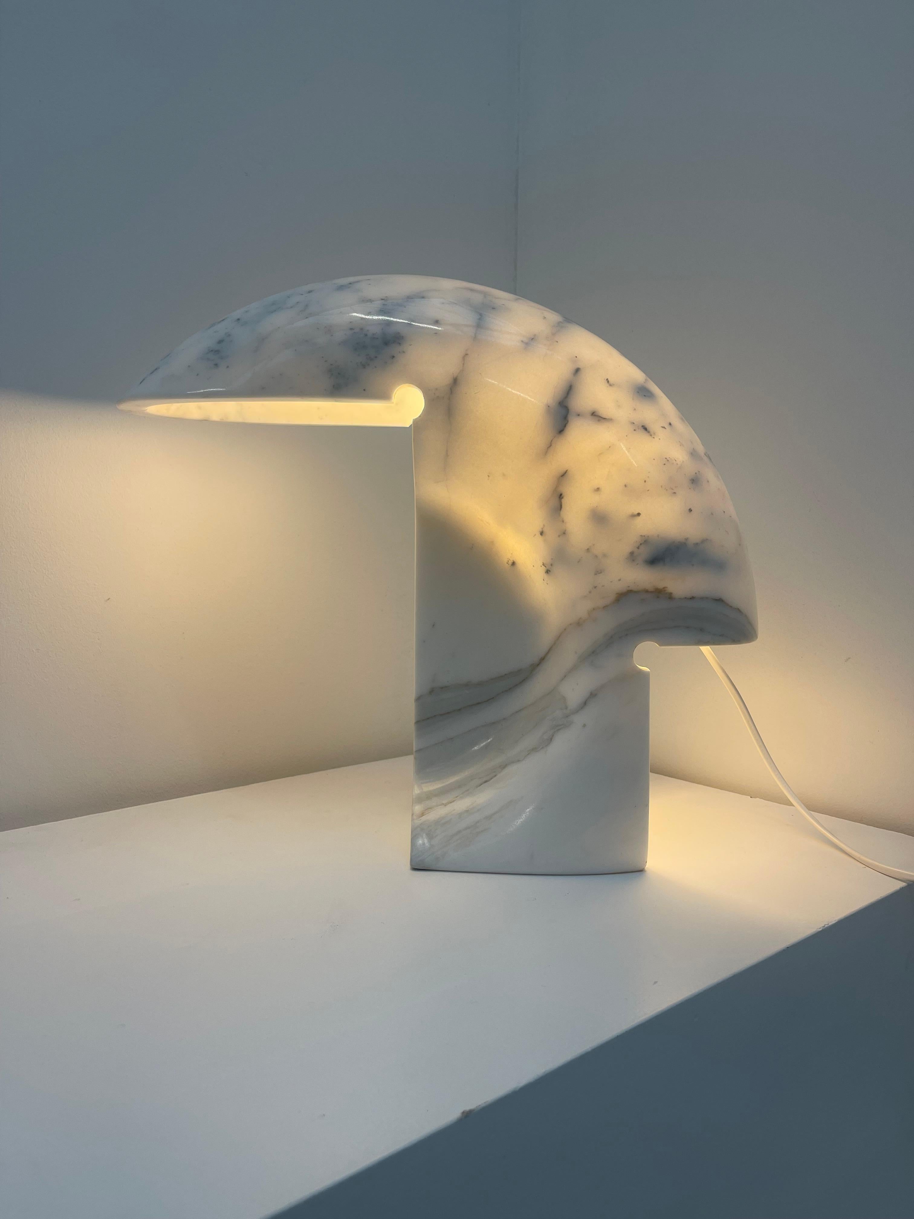 A masterpiece of sculptural design, the Biagio Table Lamp by Tobia Scarpa is an icon of modernist lighting. Carved from a single block of exquisite Carrara marble, this lamp embodies both architectural sophistication and organic beauty. Its fluid,