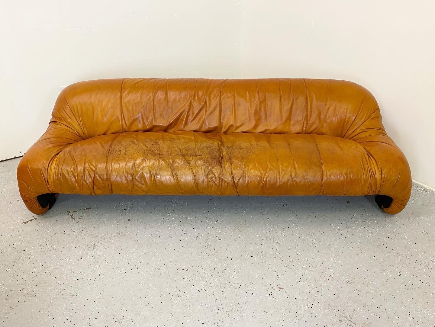 A rare early design from Afra & Tobia Scarpa for C & B Italia, Italy. Original leather shows heavy wear but is still in good usable condition. No tears or cracks to the leather. The original plastic form is in good condition with a hidden crack