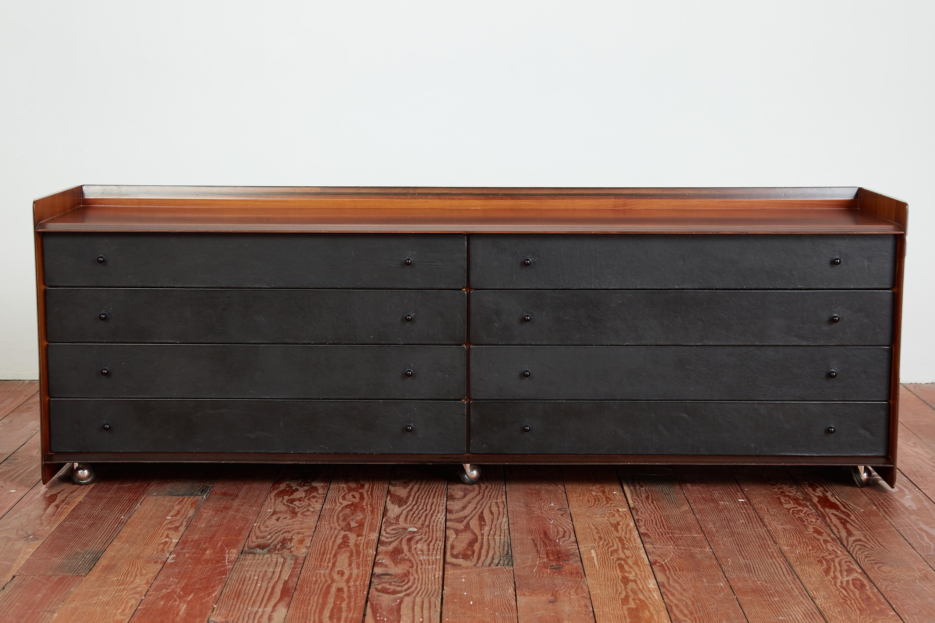 Rare Chest of drawers by Afra & Tobia Scarpa in walnut and black leather drawers. Manufactured for the Artona series for Maxalto production. 
Italy, circa 1975 

Beautiful grain in walnut 
Cabinet sits on original chrome casters.

