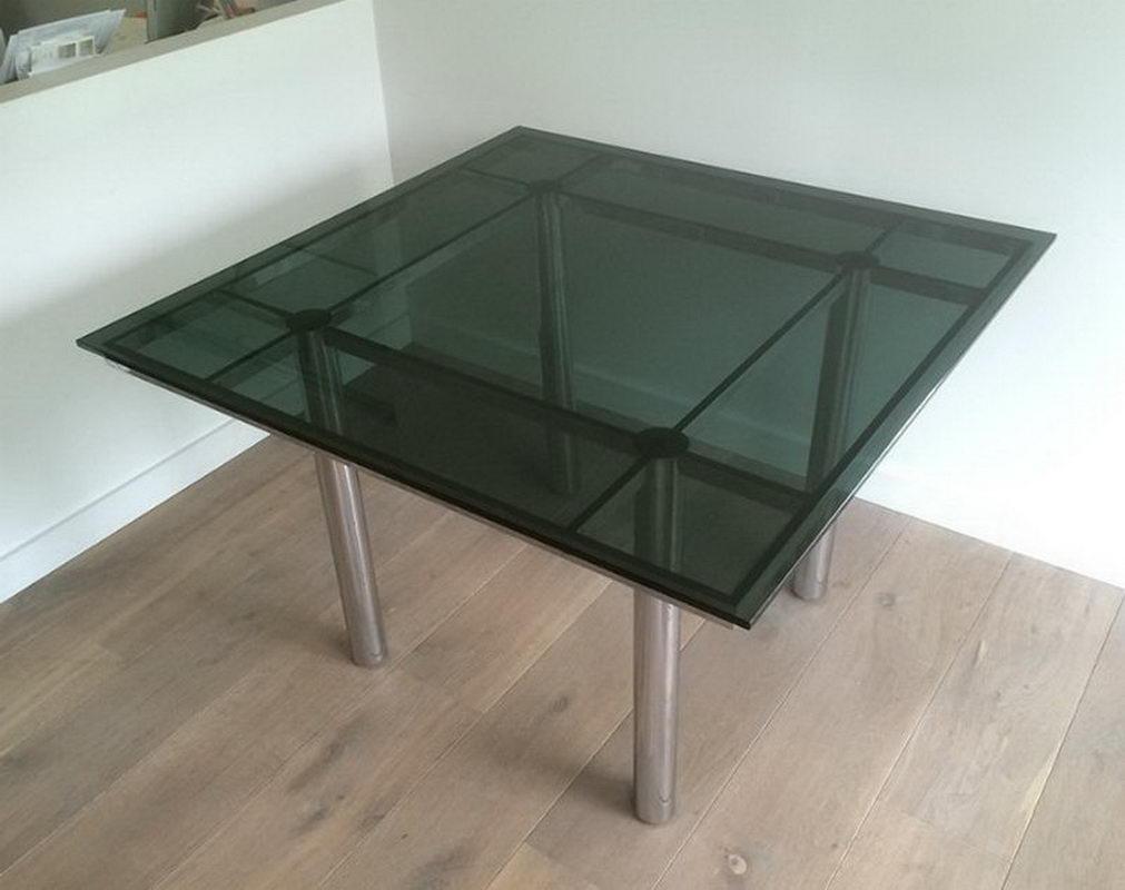 This nice design dining table is made of a chrome base with a blueish glass on top. This is a model by famous Italian designer Tobia Scarpa, circa 1970.