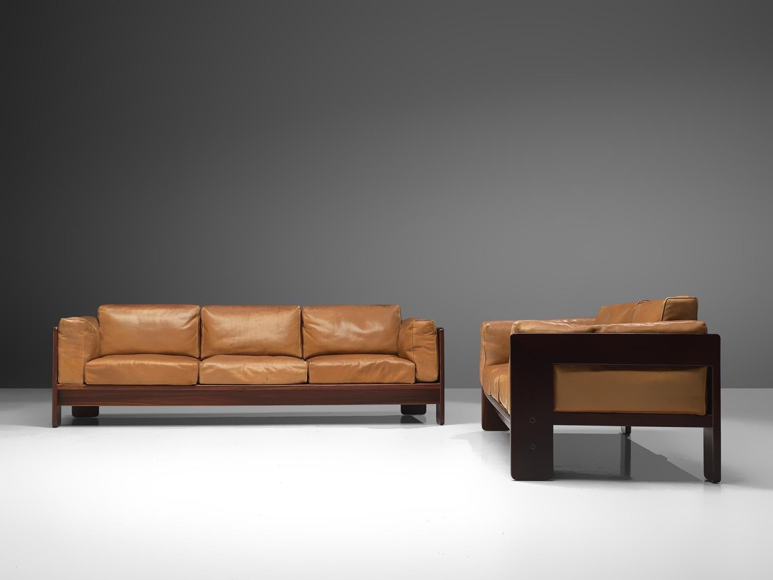 Tobia Scarpa for Knoll, pair of 'Bastiano' sofas, leather and rosewood, Italy, design 1960, manufactured between 1969-1970s.

Beautiful pair of Bastiano sofas made with a rosewood frame and cognac leather cushions. Tobia Scarpa designed the
