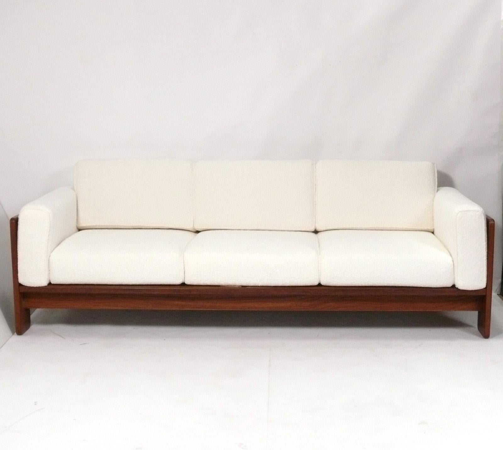 Clean Lined Rosewood Bastiano Model Rosewood Sofa, designed by Tobia and Afra Scarpa for Gavina, Italy, circa 1960s. It has been recently reupholstered in a plush ivory color boucle with all new foam inserts.