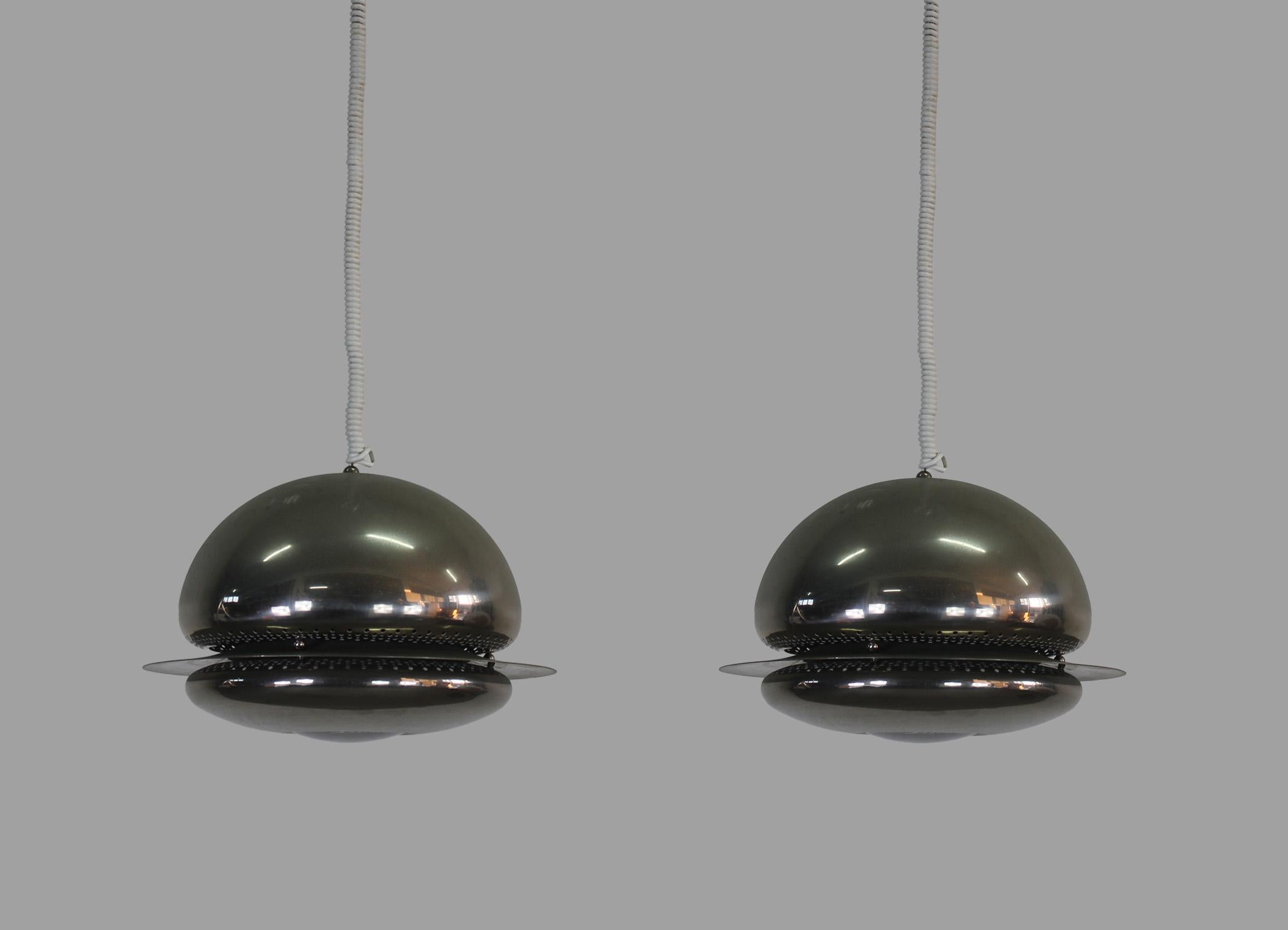 Nictea pendant lamp in nickel-plated brass, and glass was designed by Tobia Scarpa in 1961 and produced by Flos. 
The Nictea lamp gives filtered and concentrated light thanks to the perforated metal, the conjunction of the two semi-spheres, and the