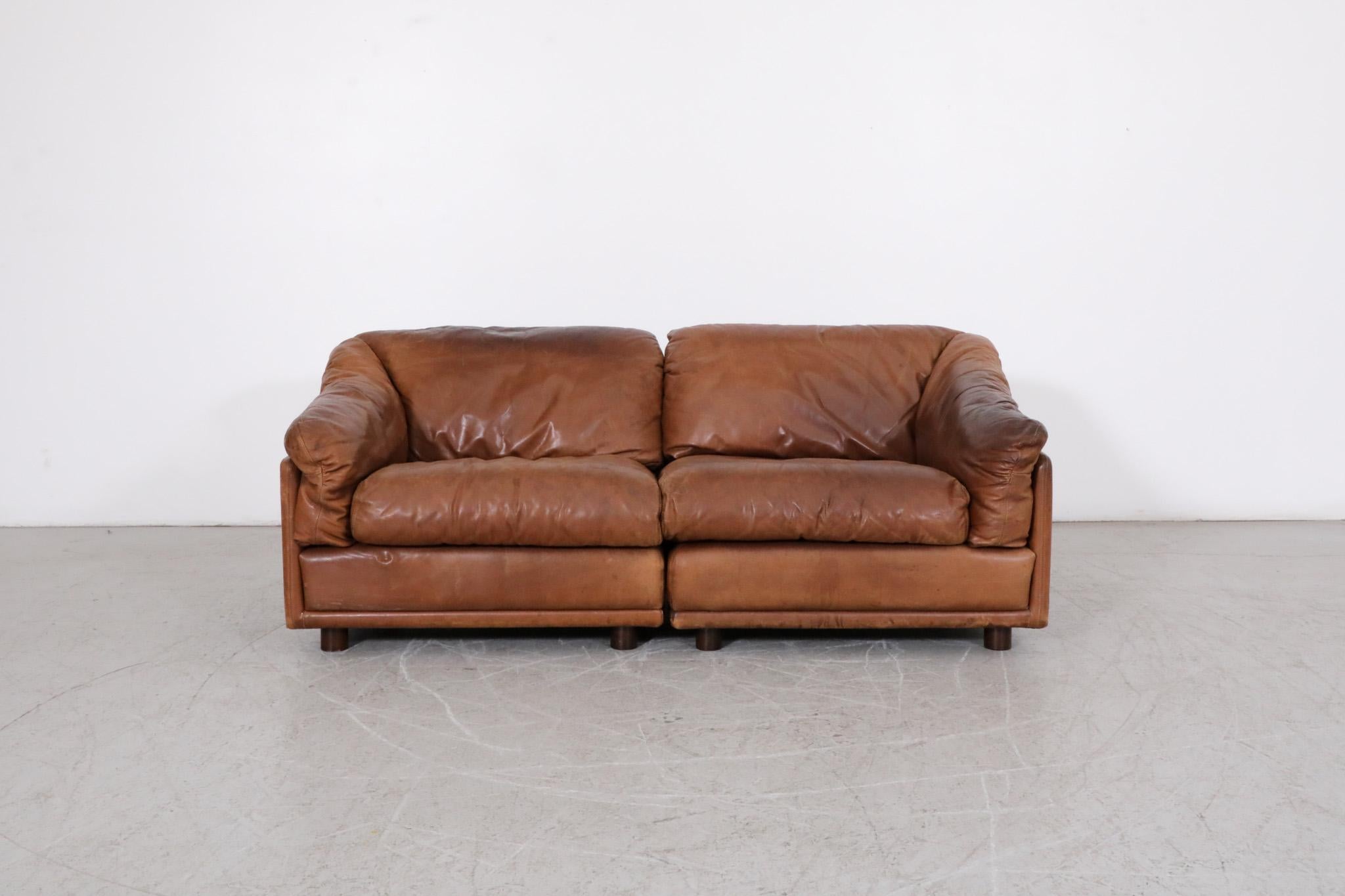 Mid-Century Leolux modular loveseat with cognac leather frame and gorgeous patina. A cozy 2 piece sofa set with removable cushions and small round wood feet. In original condition with some visible wear consistent with age and moderate use. 