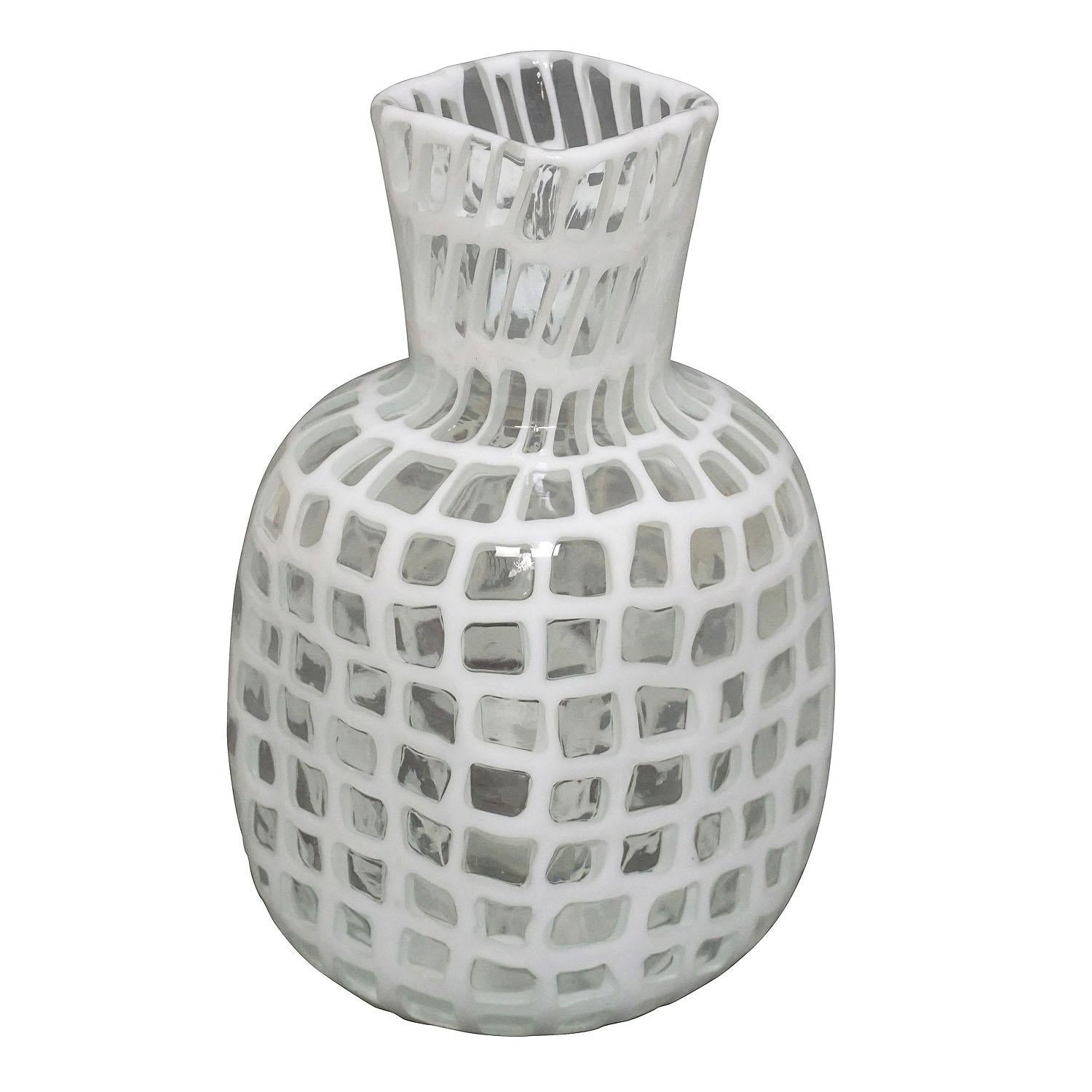 A white 'occhi' murrine vase designed by Tobia Scarpa in 1960, manufactured by Venini, Venice ca. 1960. Acid stamped signature 'venini Murano Italia' on the base (almost not visible).

In 1921 Paolo Venini and Giacomo Cappellin founded a company