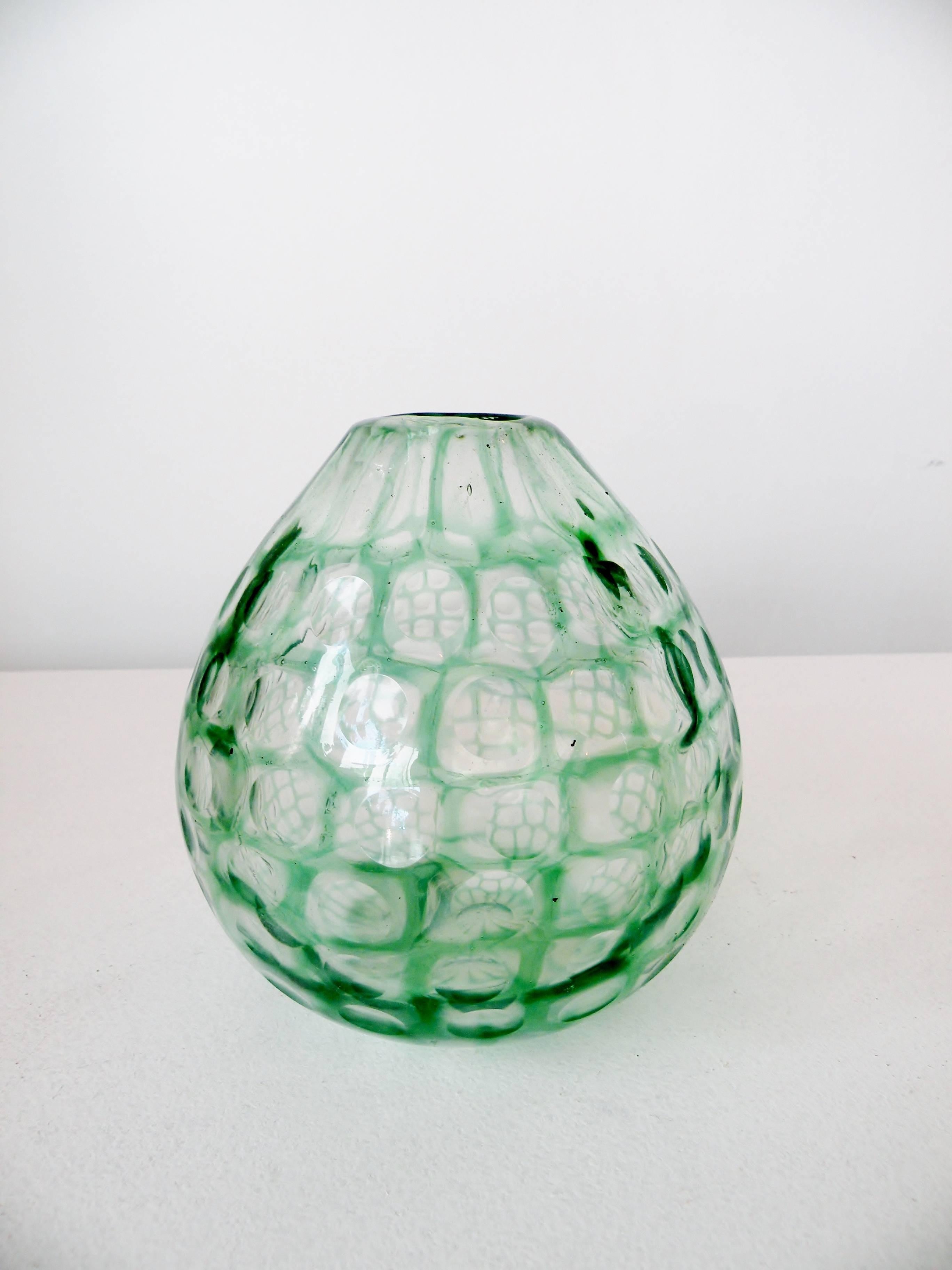 A scarce early 1960s Tobia Scarpa bulbous Occhi series vase. Green and clear art glass with cut disks around surface. Similar examples are illustrated in Le Verre Venini, Deboni, pl. 166.

This has light hard water rings from use to interior