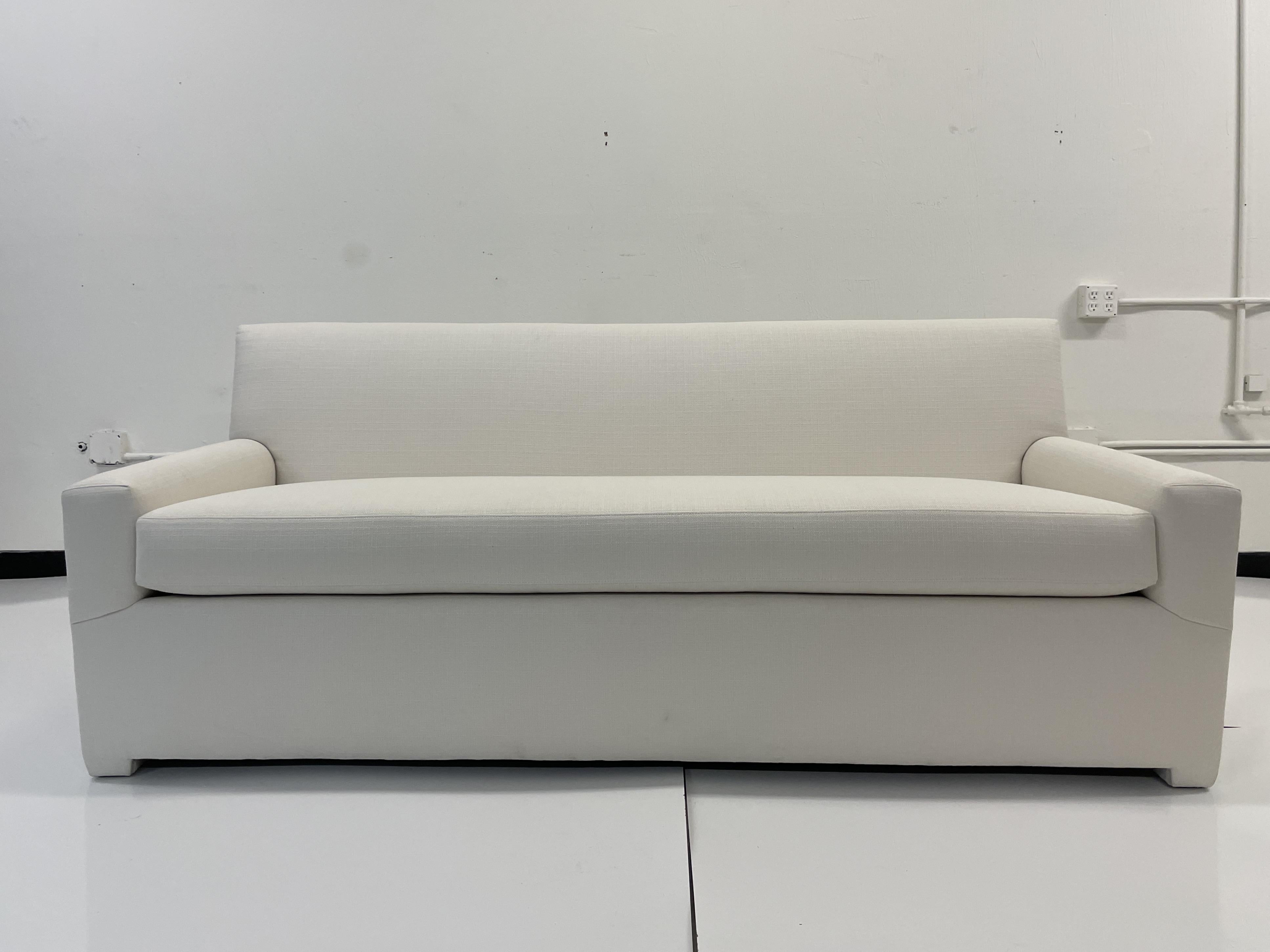 Classic modern details with old Hollywood Glam designed by Todd Hase. Add some modern elements to your living space. This Classic sofa will work well with many styles of interiors and is upholstered in Todd Hase Textiles High Performance off-white.