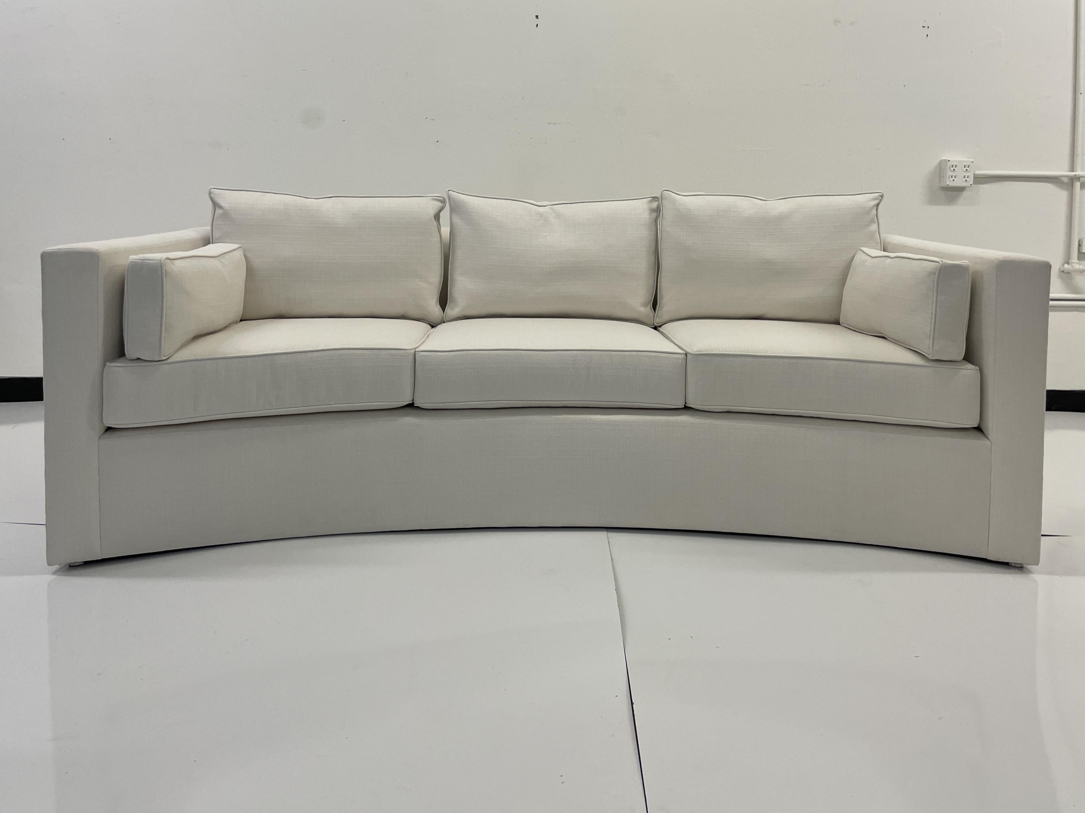 Classic Modern details with fabulous curved shapes designed by Todd Hase. Add some Modern Elements to your Living Space. This classic sofa will work well with many styles of interiors and is upholstered in Todd Hase textiles high performance off