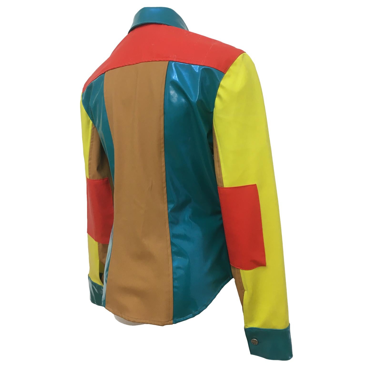 Todd Oldham Times Seven blouse / Jacket from 1990s. 
Features multi bright colour vinyl materials and buttons along the center front. Beautifully shaped waist line. Very rare find.
Fits like 36 EU.