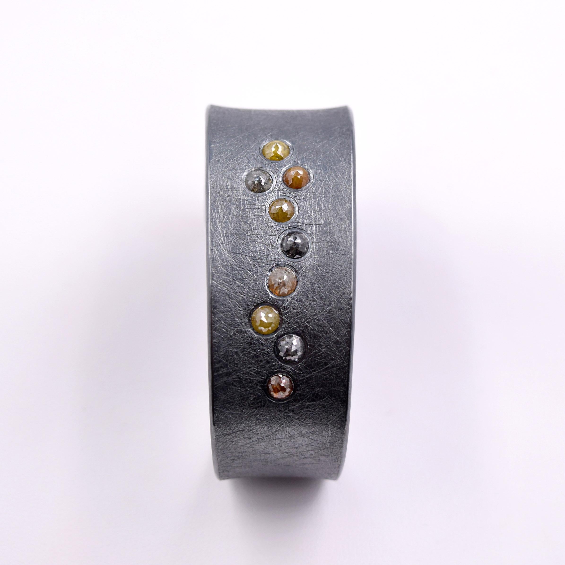 Todd Reed's iconic Bracelet is a hand forged and textured piece of wearable art.
Colored rose cut Diamonds give this piece of Jewelry the edgy refinement that Jewelry wearers have come to expect from Todd Reed.
4.48 Carats of Diamonds set in a