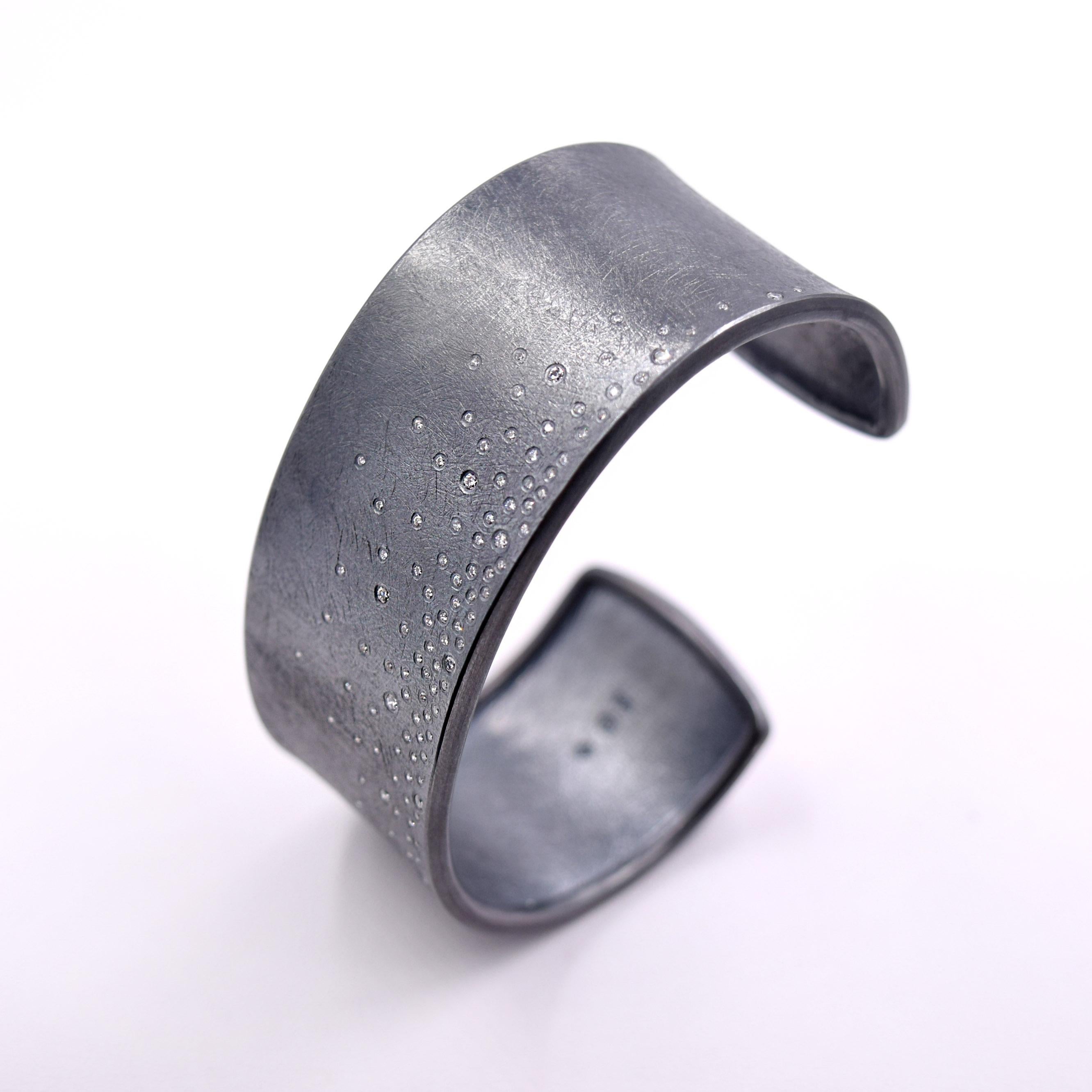 Todd Reed's iconic Bracelet is a hand forged and textured piece of wearable art.
Flush set Diamonds sprinkled throughout the Bracelet give this piece of Jewelry the edgy refinement that Jewelry wearers have come to expect from Todd Reed.
The total