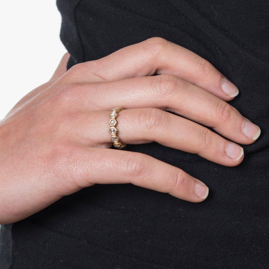 Exemplifying the hidden beauty within unpolished diamonds, Todd Reed transforms earth’s natural elements into raw elegance.

Embellished with white rose cut diamonds, this hexagonal 18k yellow gold band by Todd Reed pays homage to the humble yet