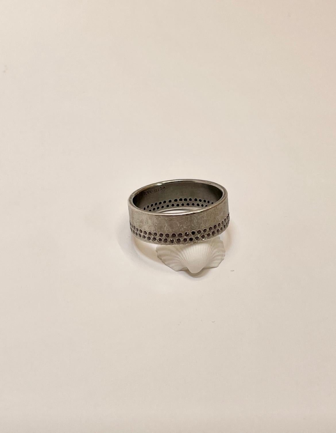 Lightly worn one of a kind mens fashion ring.  This ring would also make a very great and contemporary wedding band.  The design uses a sterling silver core with a 950 Palladium overlay on the surface.  Palladium gives the ring its cool gray blue