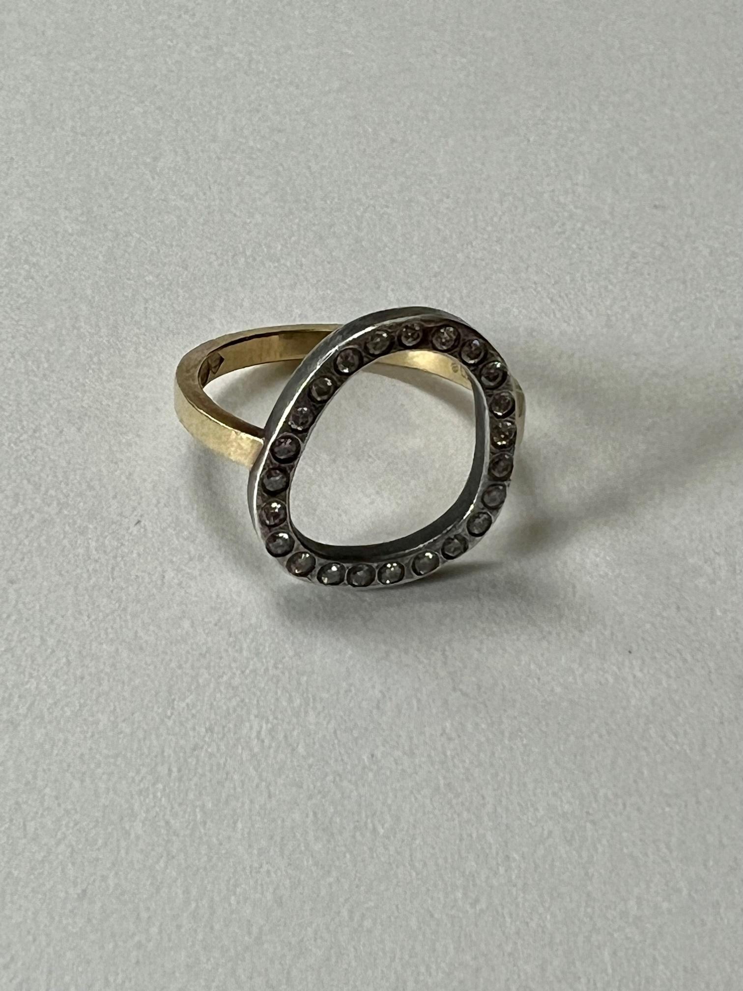Todd Reed White Diamond Gold And Silver Open Frame Ring.

White Brilliant cut diamonds flush set in sterling silver halo on top of an 18k gold band. The halo has a dark patina finish to it.  If purchased and desired we are happy to refurbish and