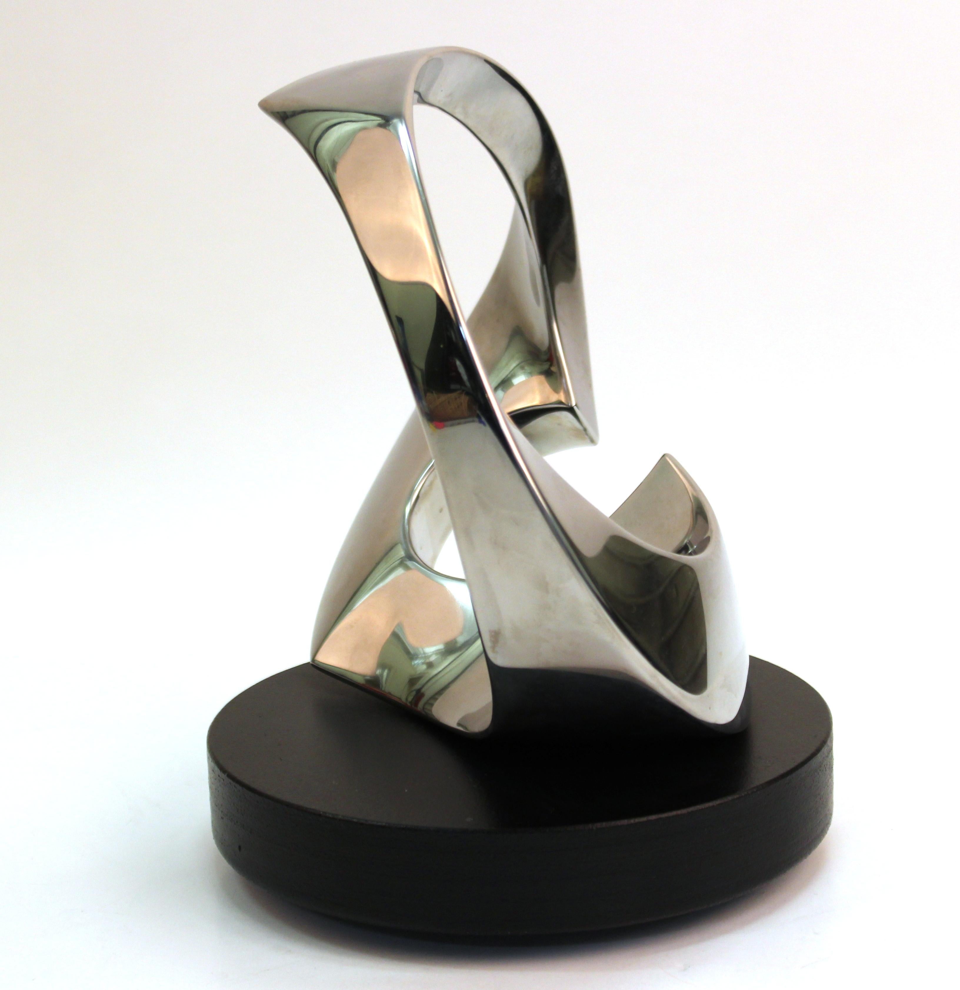 Modern metal abstract sculpture by Todd Reuben, on rotating base, marked 'Sculpture 56'. Marked on the base 'Sculpture 56 - Todd Reuben - 9 6 96'. The piece is in great vintage condition with age-appropriate wear.