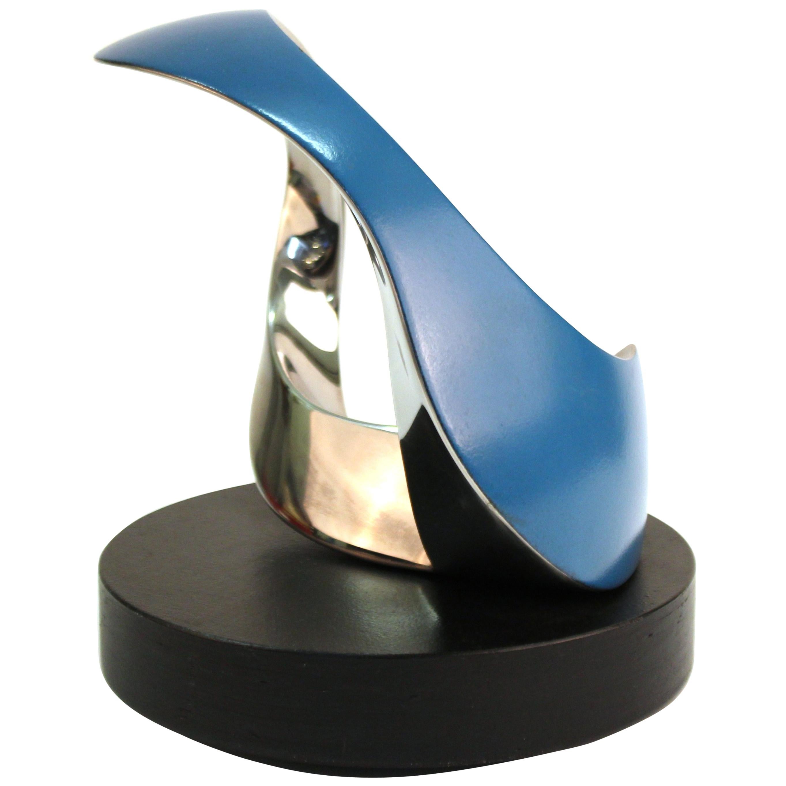 Modern metal abstract sculpture with partial blue coating by Todd Reuben, on rotating base, marked 'Sculpture 45'. Marked on the base 'Sculpture 45 - Todd Reuben - 7 30 95'. The piece is in great vintage condition with age-appropriate wear.