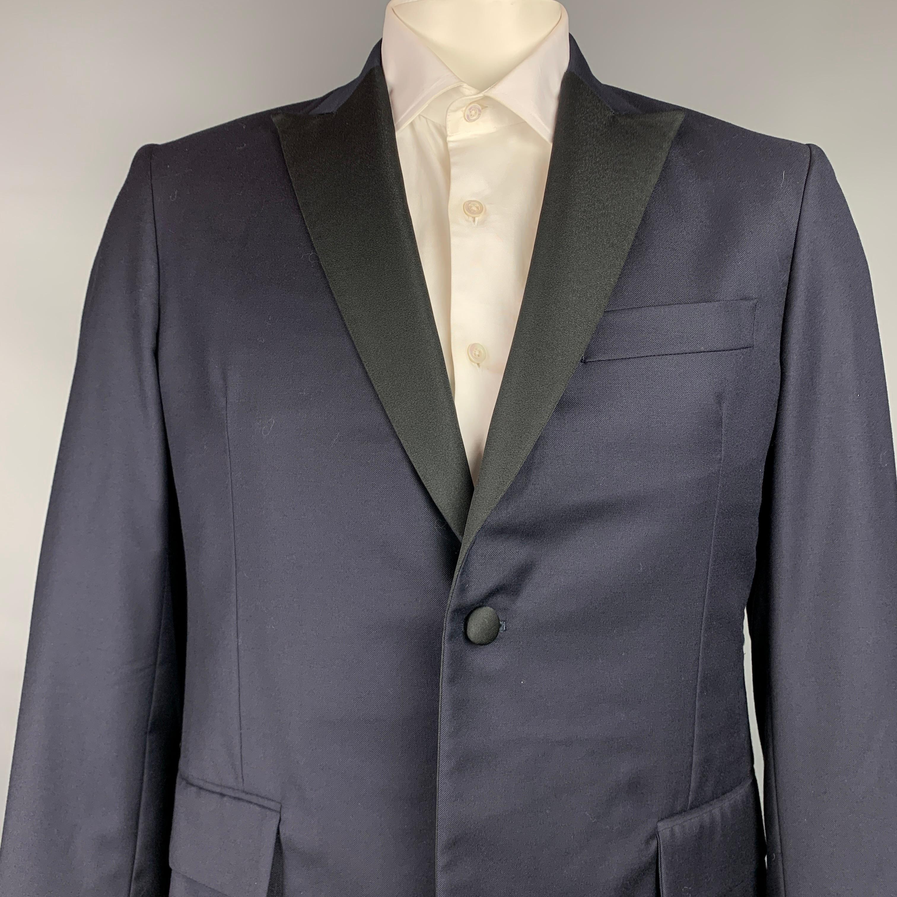 TODD SNYDER sport coat comes in a navy & black wool with a half liner featuring a peak lapel, flap pockets, and a single button closure. Made in USA.

Very Good Pre-Owned Condition.
Marked: 42R

Measurements:

Shoulder: 18 in.
Chest: 42 in.
Sleeve: