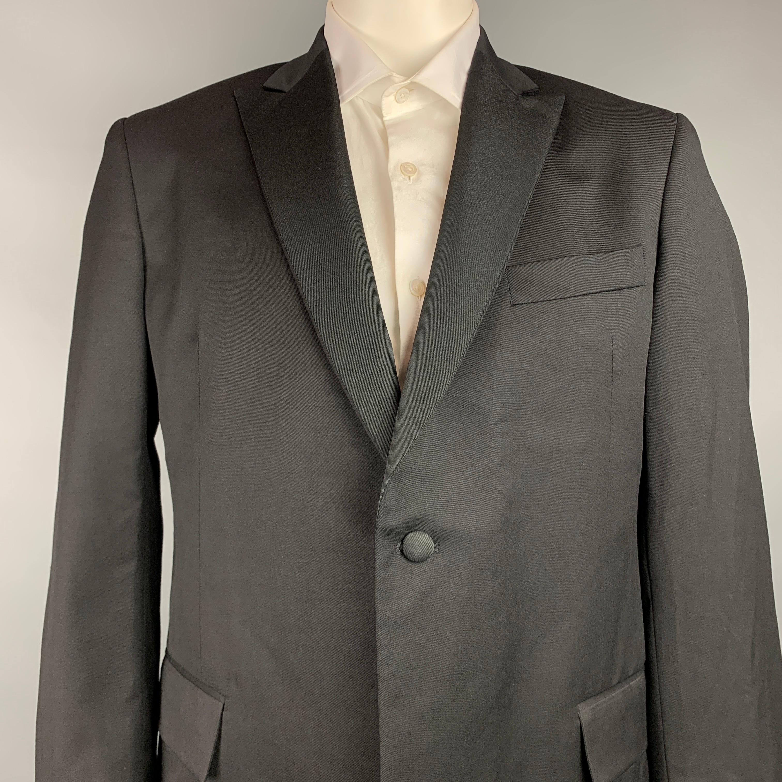 TODD SNYDER sport coat comes in a black wool with a full liner featuring a peak lapel, flap pockets, and a single button closure. Made in USA.

Very Good Pre-Owned Condition.
Marked: 44L

Measurements:

Shoulder: 19 in.
Chest: 44 in.
Sleeve: 26
