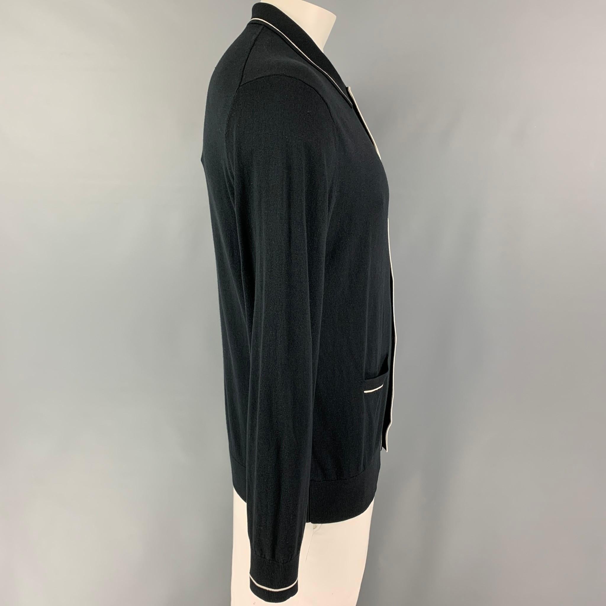 TODD SNYDER cardigan comes in a navy & white silk / cotton featuring a spread collar, front pockets, and a buttoned closure. 

Very Good Pre-Owned Condition.
Marked: L

Measurements:

Shoulder: 19 in.
Chest: 44 in.
Sleeve: 27.5 in.
Length: 28.5 in.