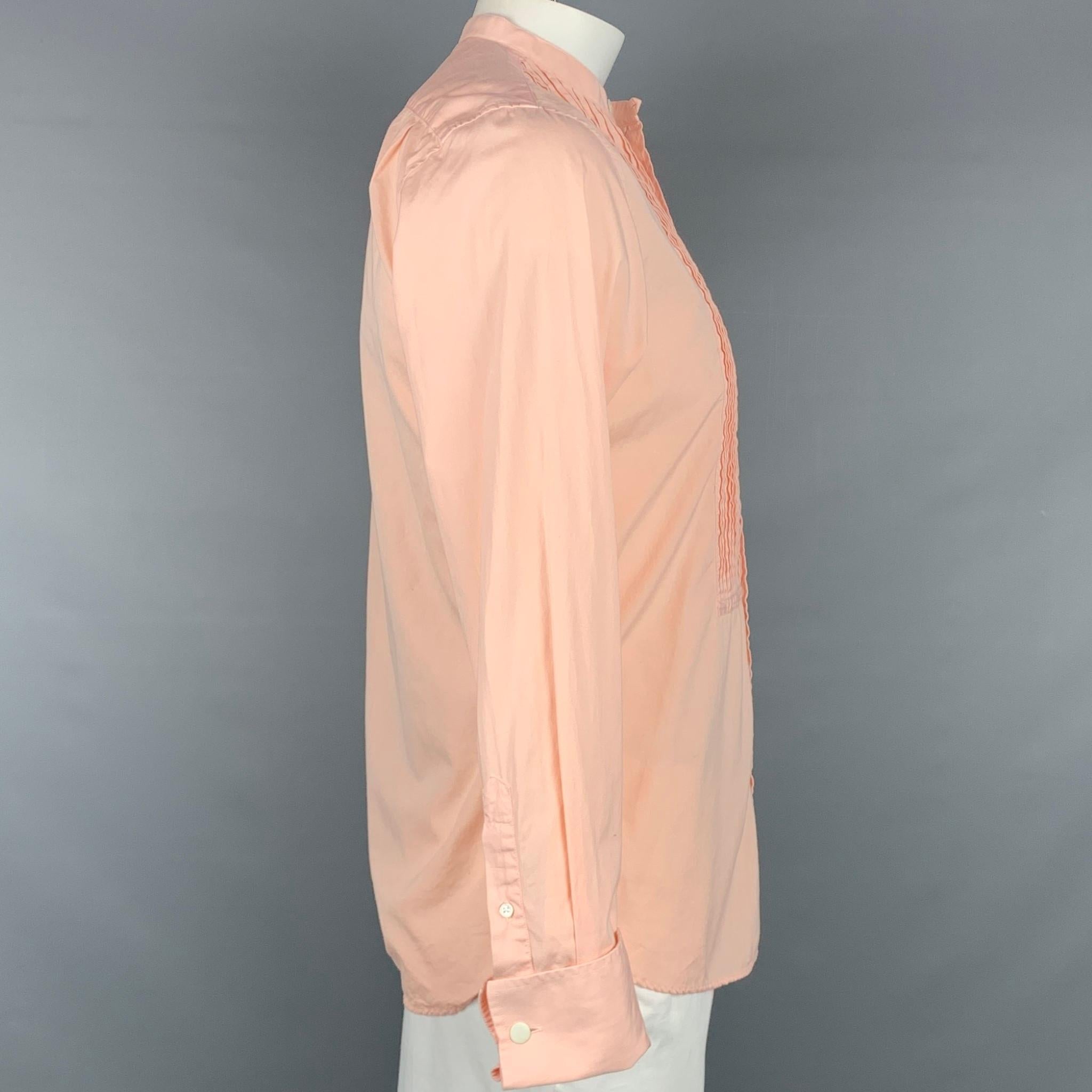 TODD SNYDER long sleeve shirt comes in a peach cotton featuring a nehru collar, pleated front, french cuffs, and a button up closure. Cufflinks not included. Made in Portugal.

Very Good Pre-Owned Condition.
Marked: M

Measurements:

Shoulder: 17.5