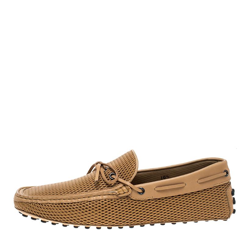 Bring up your everyday casual wear game by adding these stylish Tod’s loafers to your collection. Designed in beige diamond laser cut leather, these loafers are accented with gunmetal tone metal eyelet details which holds the lace that ties up as a