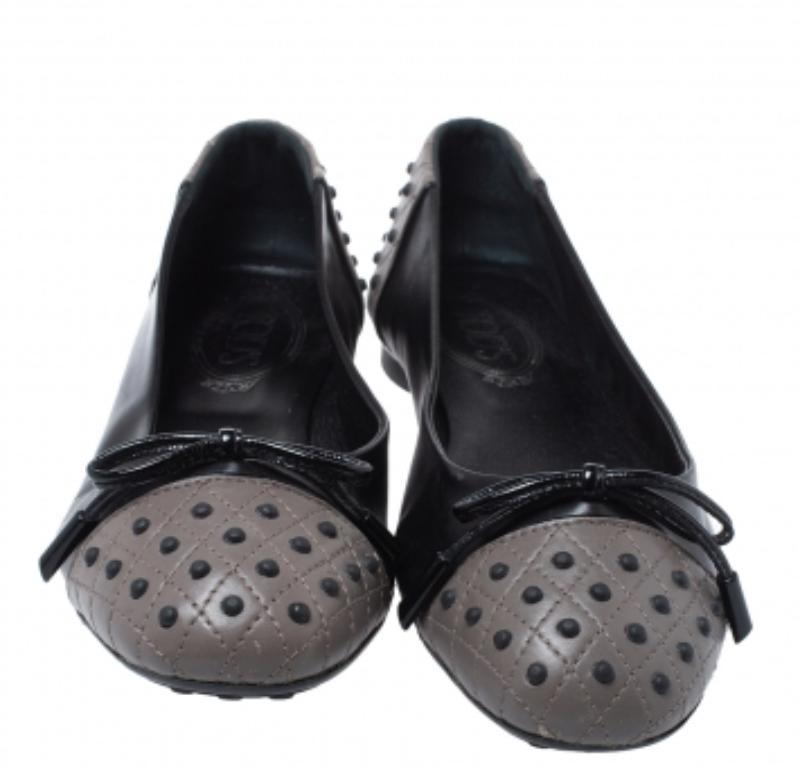 These ballet flats from Tod's are simply amazing and impress with their black and grey leather construction. They feature round toes with stitch detailing and delicate bows on the vamps. Comfortable insoles and durable rubber soles complete this