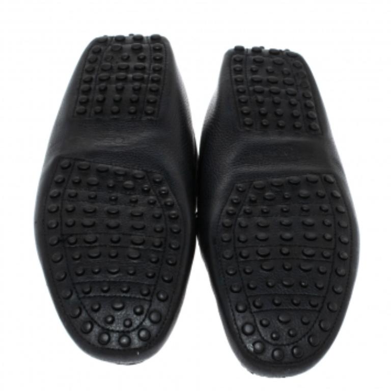 The charm of these loafers is the comfort factor and the double T accent on the uppers. Made from black leather, these shoes by Tod's are set on pebbled soles and shaped to cover your feet with luxurious ease.