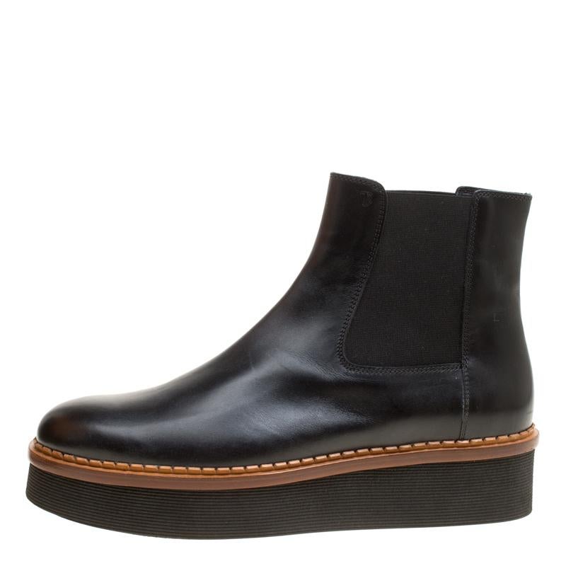 Crafted exquisitely from black leather, these Tod's boots were built to lift your outfits and your spirits. They carry round toes, stretch band inserts and platforms. The insoles are lined with leather and overall, the pair looks just right to hit a