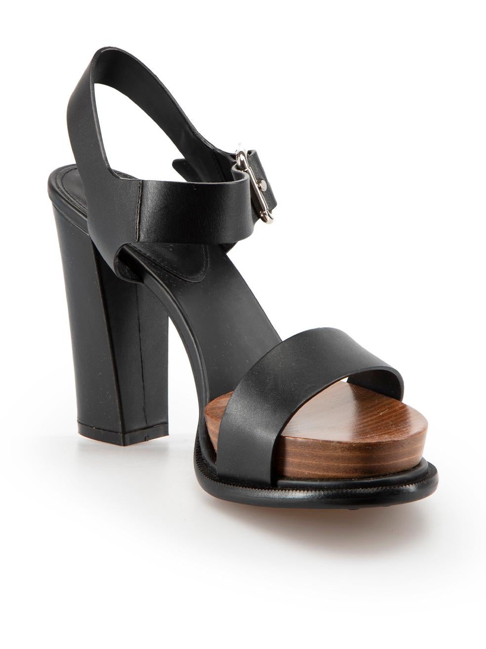 CONDITION is Never Worn. No visible wear to sandals is evident, however the right shoe heel has a small indent to the leather due to poor storage on this used Tod's designer resale item.
  
Details
Black
Leather
Heeled sandals
Open toe
Wooden