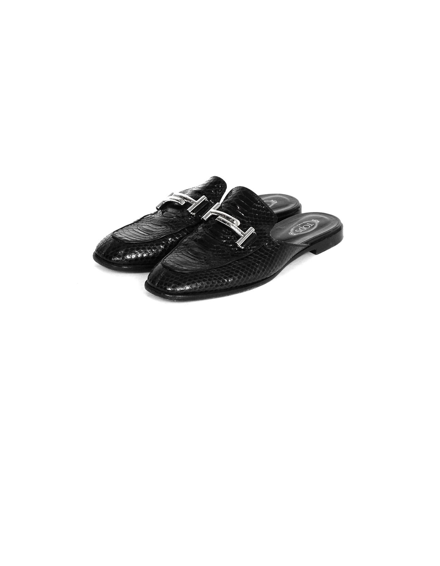 Tod's Black Snakeskin Double T Mules sz 40

Made In: Italy
Color: Black
Hardware: Silvertone
Materials: Snakeskin
Closure/Opening: Slip-on
Overall Condition: Very good pre-owned condition, with the exception of wear on the soles and the heels, and
