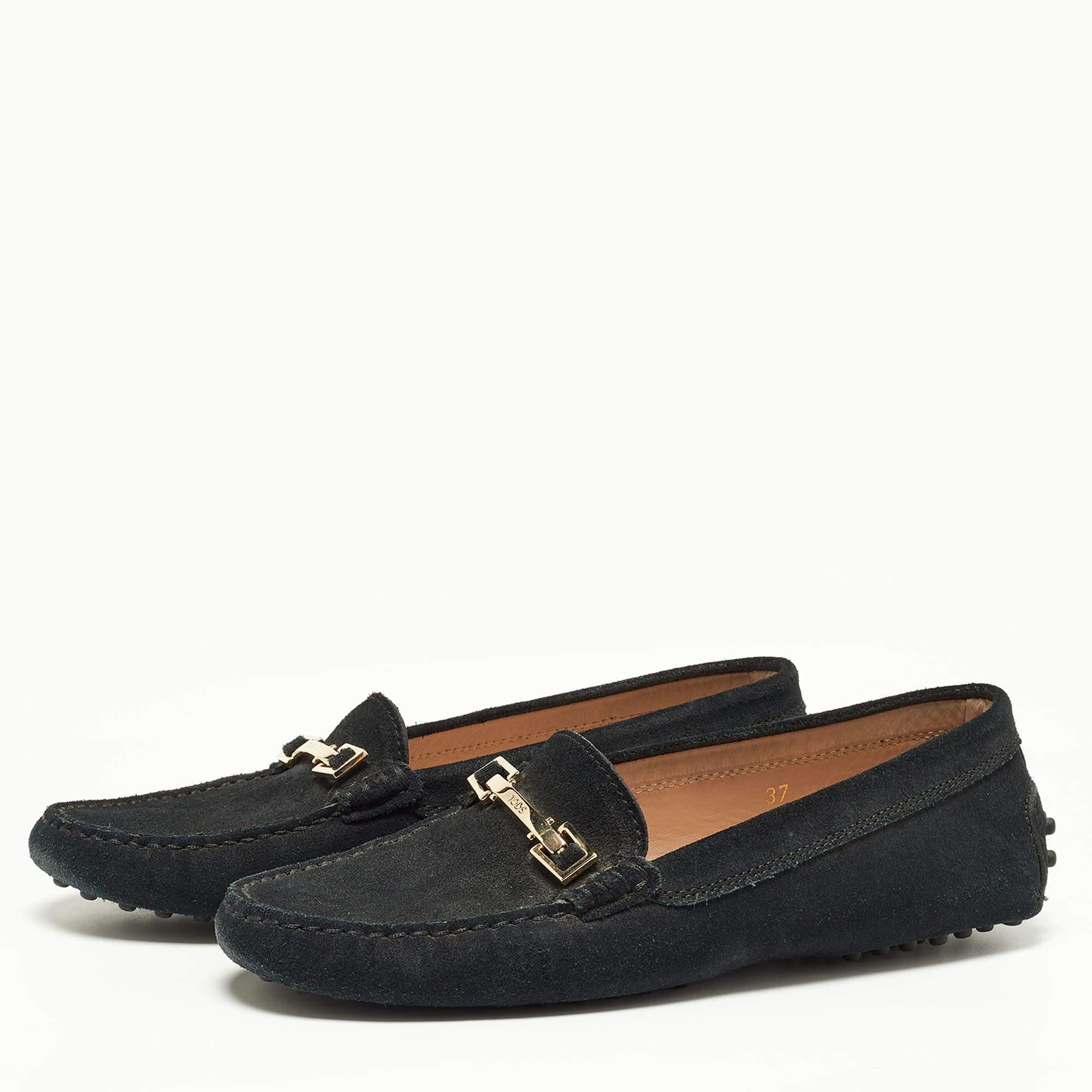 The beauty of these loafers is the comfort factor and the accent on the uppers. Made from black suede these flats by Tods are lined with leather and shaped to cover your feet with bliss.