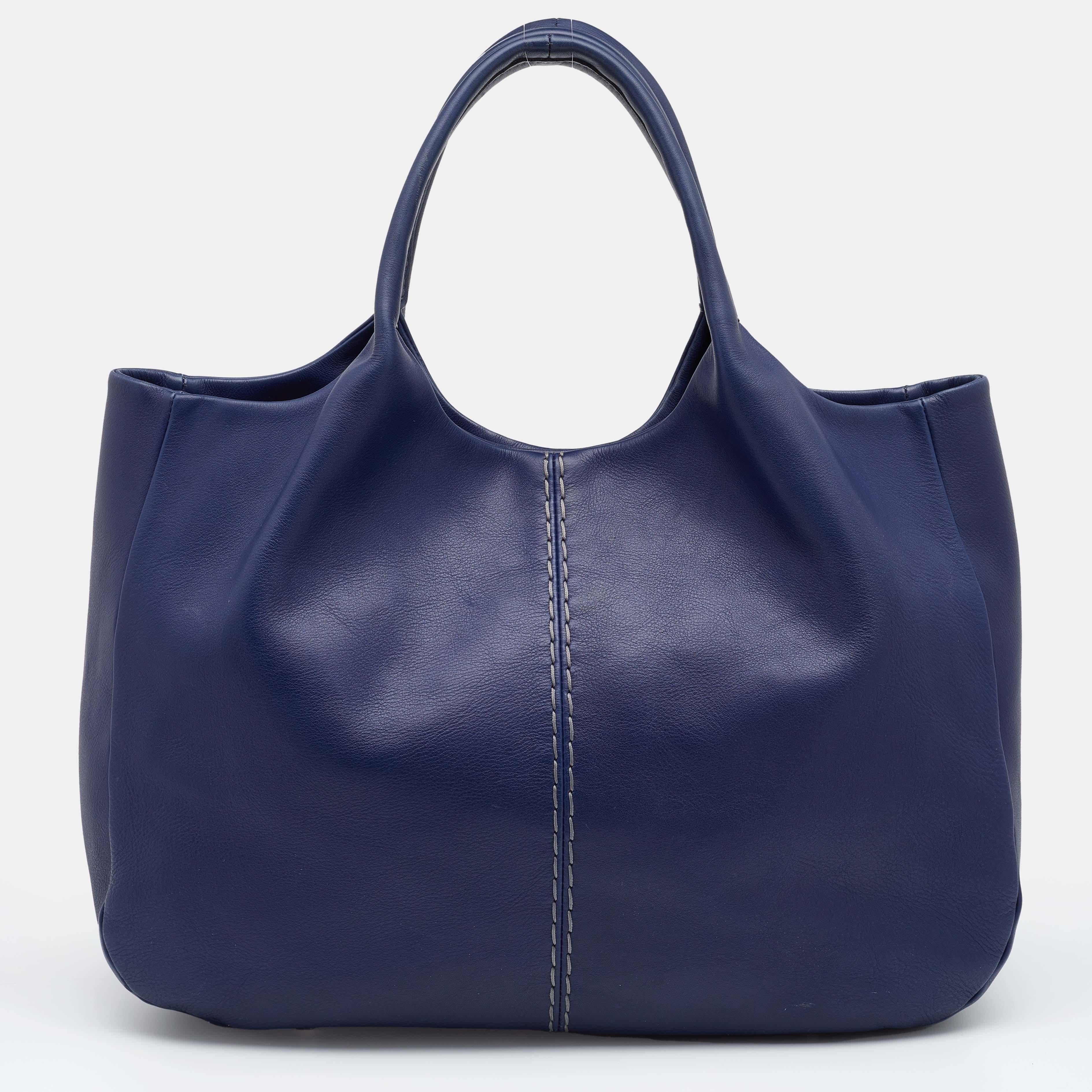 With a functional design, this Tod's tote works well as an everyday accessory. It comes created from leather and is held by dual handles at the top. Lined with fabric, its interior has enough space to easily accommodate your daily essentials. The