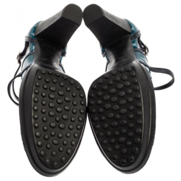 You will surely adore these ultra-chic and feminine pumps from Tod's. Crafted from blue patent leather, these pumps are accented with strappy details, round toes, and silver-tone buckles on ankle straps. The insoles are lined with leather and