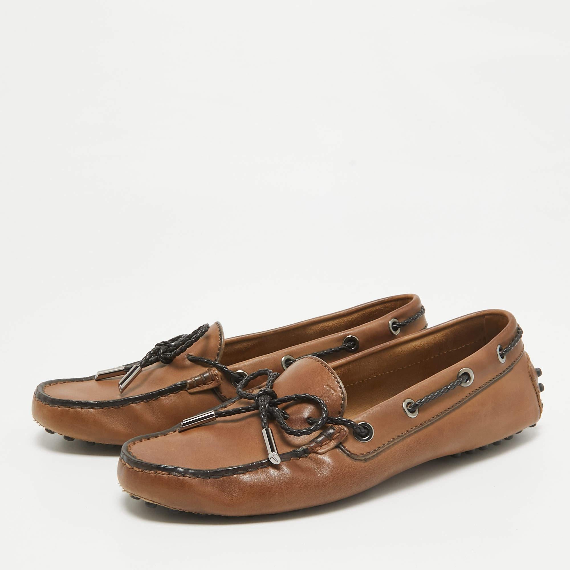 Let comfort and classic style be yours with these designer loafers from Tods. Crafted with skill  the high quality shoes have the perfect construction to take you through the day with ease.