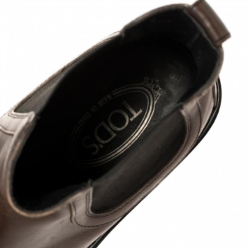 These ankle boots from Tod's are totally chic and stylish! They are crafted from brown leather and designed with round toes. They are equipped with comfortable leather-lined insoles and finished with tough rubber soles. They'll look great with smart
