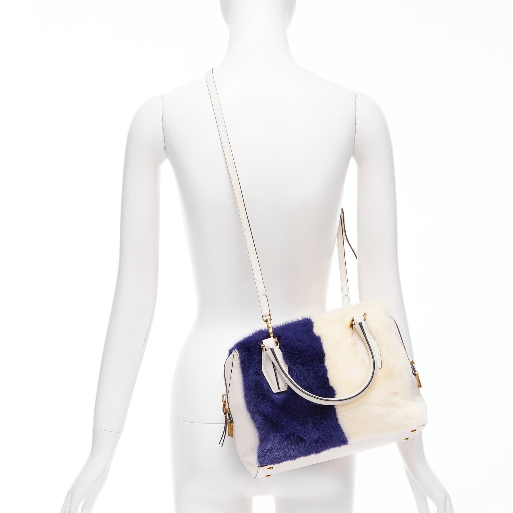 TOD'S D Cube Bauletto cream blue fur white leather GHW bowler bag
Reference: NILI/A00054
Brand: Tod's
Model: D-Cube
Material: Leather, Fur
Color: Blue, Cream
Pattern: Solid
Closure: Zip
Lining: Navy Fabric
Made in: Italy

CONDITION:
Condition: Good,