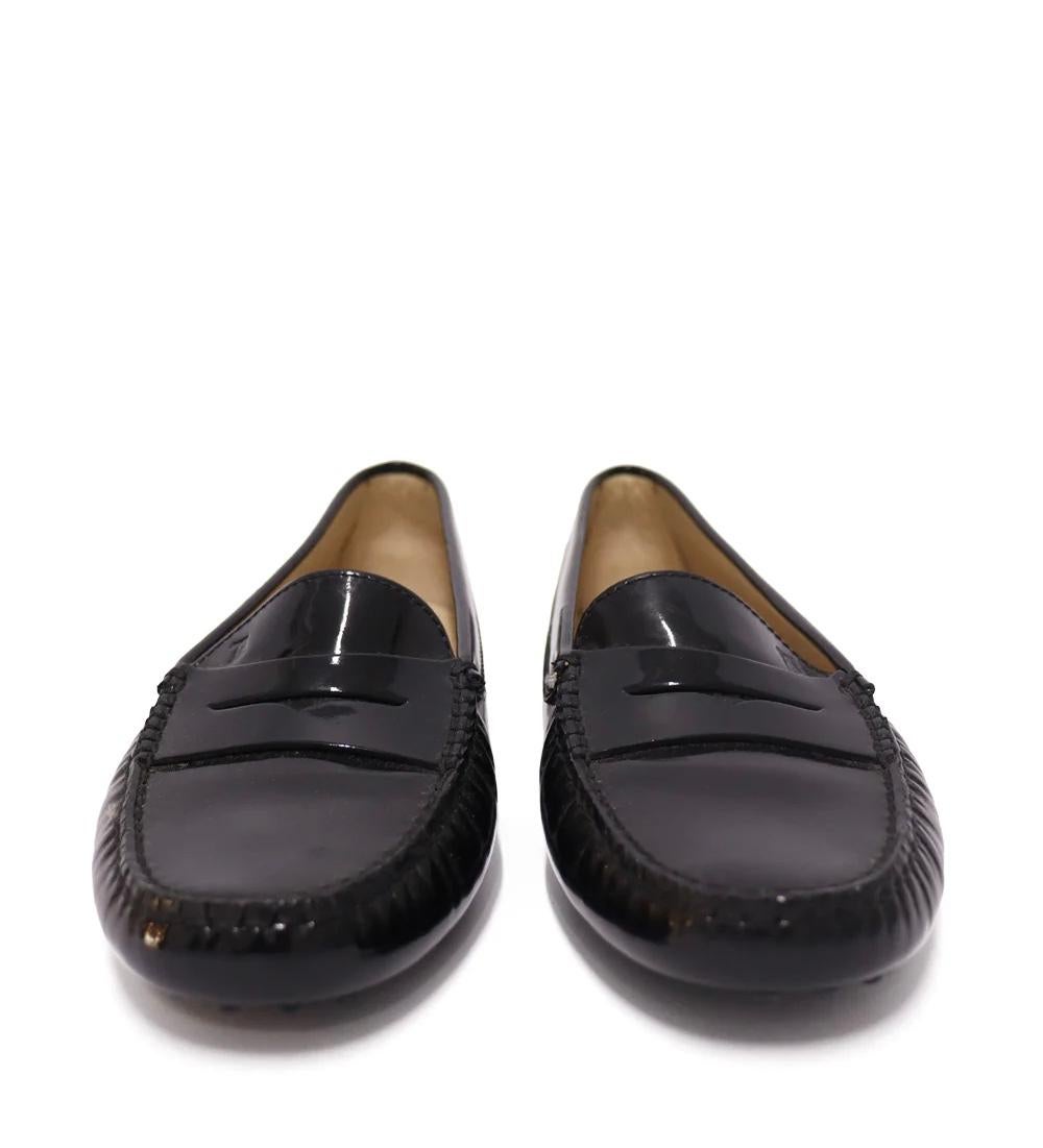 Tod's Black Gommino patent leather moccasins. Assembled with hand-stitched panels, signature tonal pebbled soles and heel counters.

Material: Patent Leather
Size: EU 37.5
Overall Condition: New
*Include box
