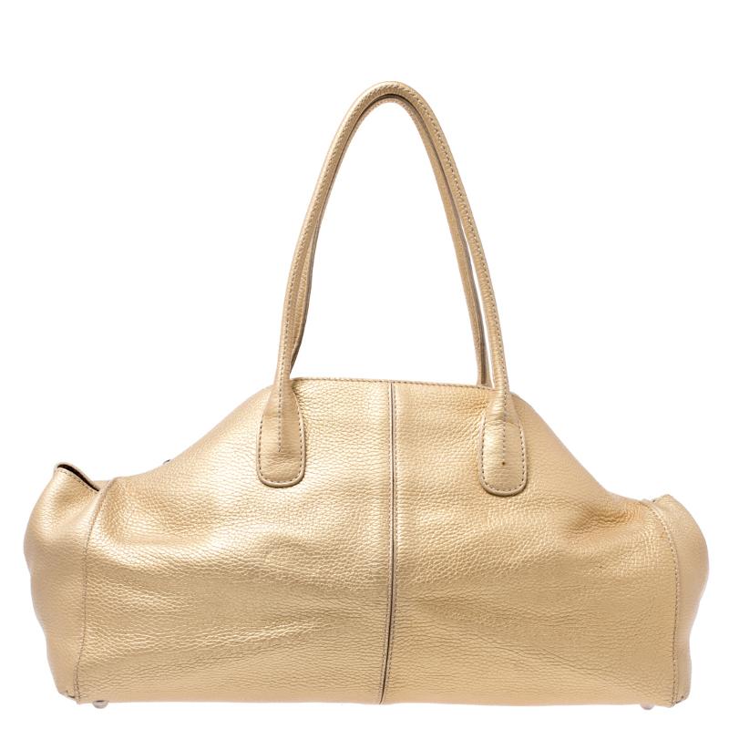 Minimal in design but high in style and craftsmanship, this bag from Tod's smoothly blends luxury with practical fashion. It comes crafted from gold leather and is styled with two top handles and a spacious suede interior.

Includes: The Luxury