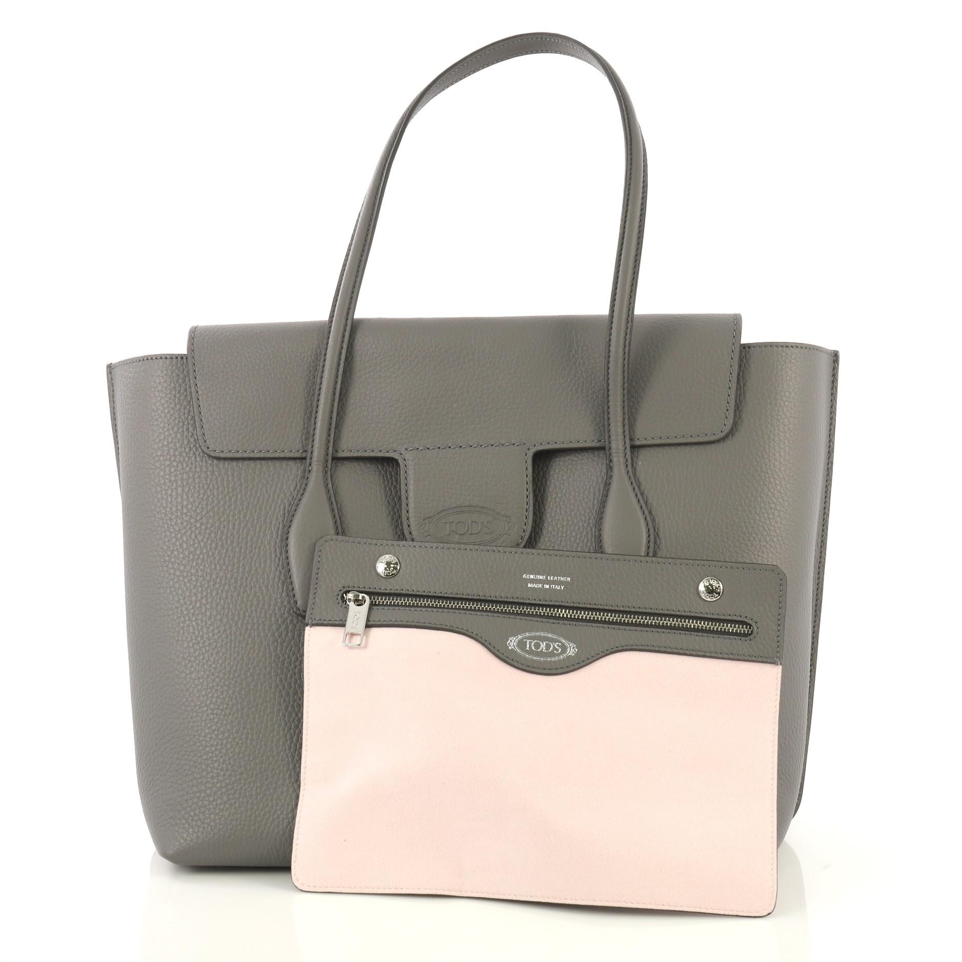 This Tod's Joy Flap Satchel Leather Medium, crafted from gray leather, features dual slim leather handles, front flap compartment, and silver-tone hardware. It opens to a light pink microfiber interior with zip pocket. 

Estimated Retail Price: