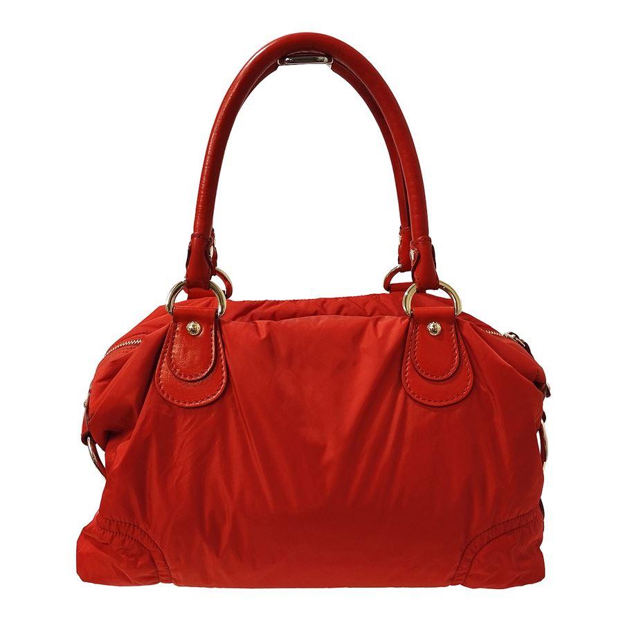 Nylon and leather Red color Two handles Golden metal Zip closure 2 external pockets Internal zip pocket Cm 35 x 20 x 12 (13,77 x 7,8 x 4,72 inches)