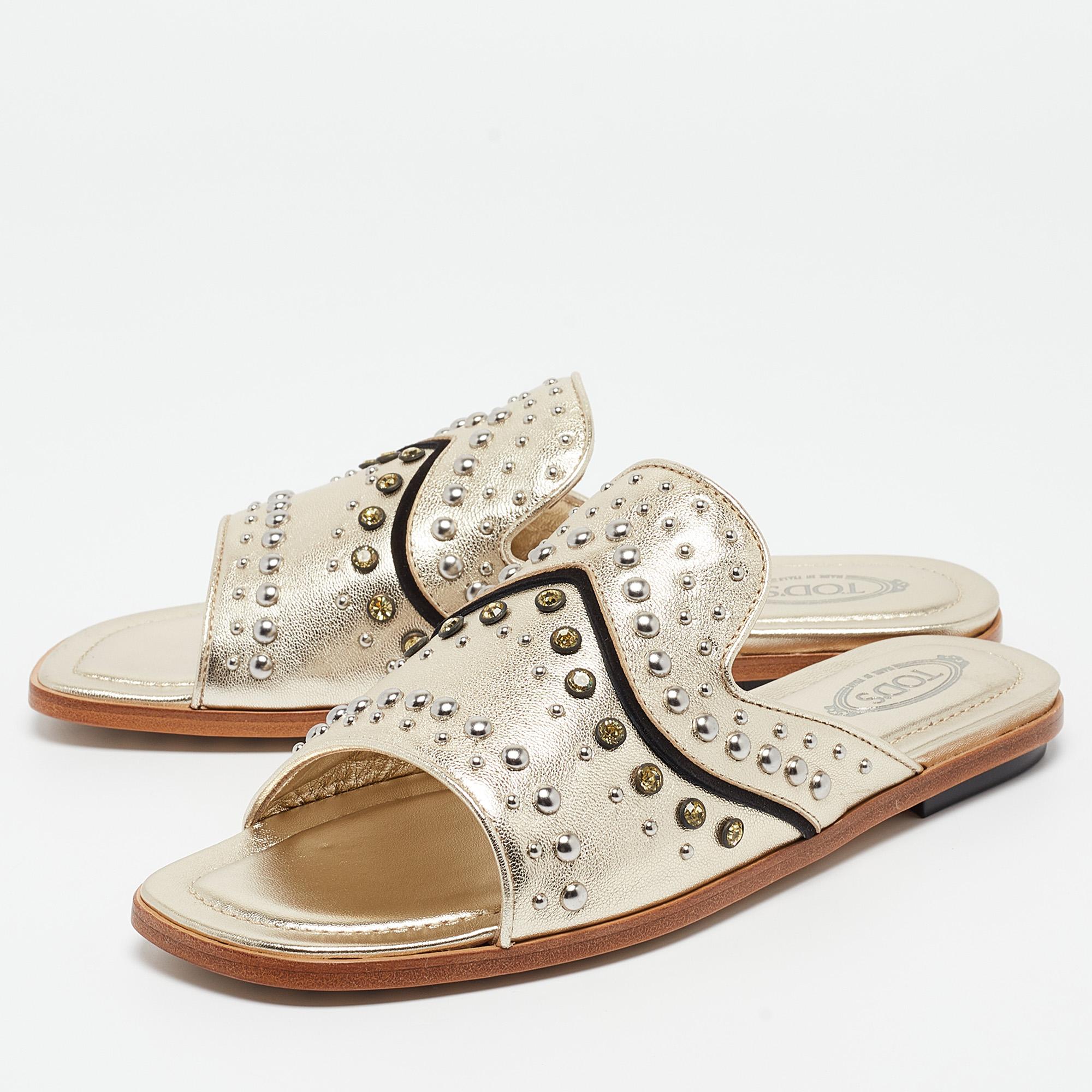 Designed with gorgeous metallic gold leather, these Tod's slides are simply divine! They've been beautifully detailed with stud-embellished uppers and open toes. Smooth insoles and sturdy soles make the sandals totally comfy and ready to be yours.