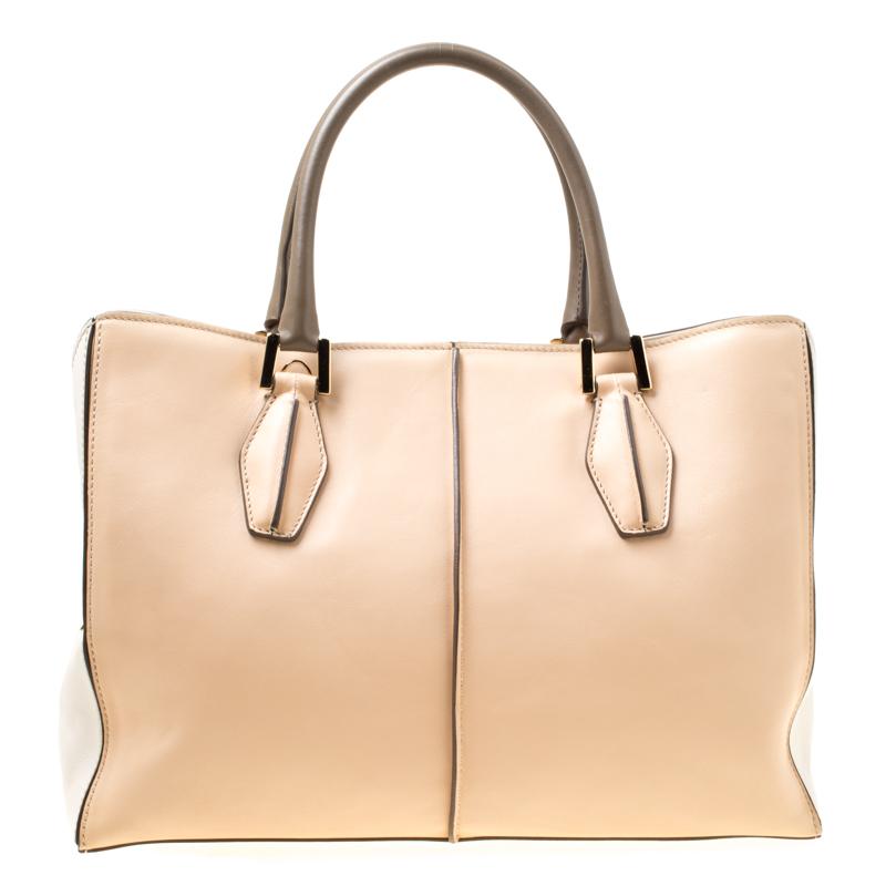 This functional design from Tod's is stylish and handy. This bag is crafted from leather and features dual top handles, a removable shoulder strap and a satin lined interior. The interior has ample space to store your essentials and comes with a
