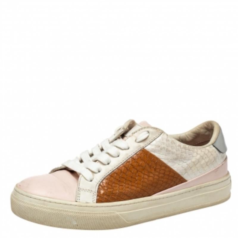 These sneakers by Tod's are one of a kind. Crafted from leather and exotic python skin, these low-top sneakers are stylish and versatile. They feature lace-up fronts, leather lining, insoles, and rubber soles. They are finished impeccably and can be