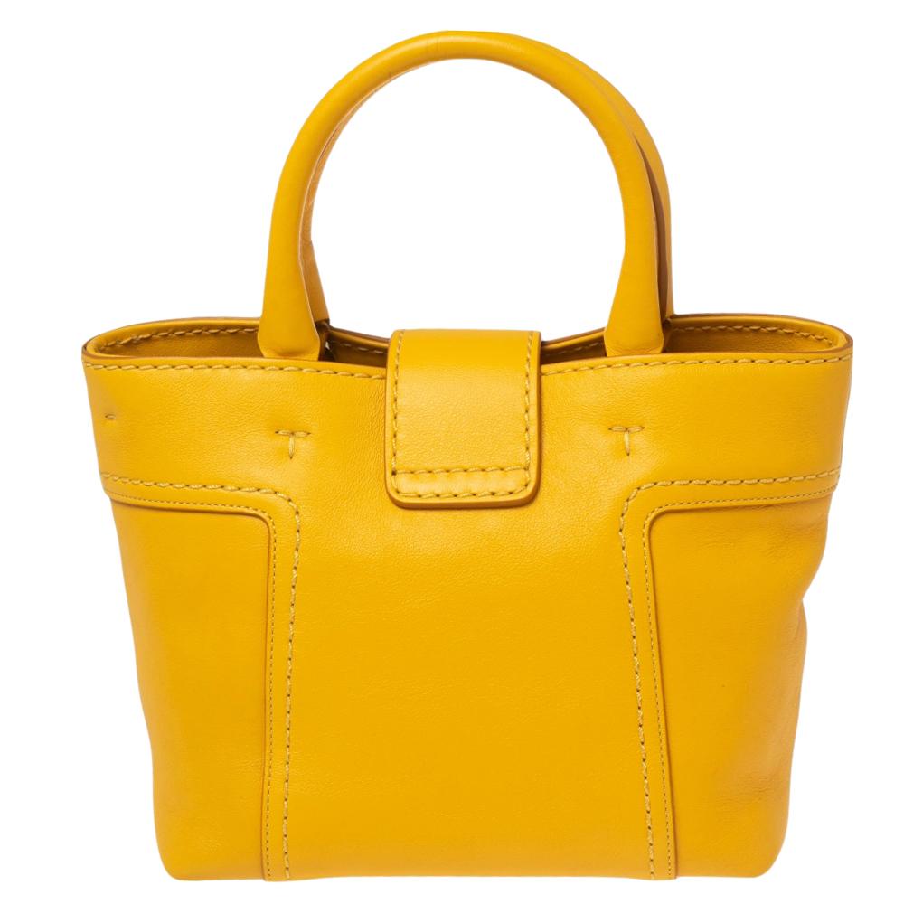 Make heads turn by carrying this lovely shoulder bag from Tod's. With its bright mustard yellow hue, it is sure to make you feel stylish and unique. It is complete with a double handle and a well-sized interior to fit in your belongings.

Includes: