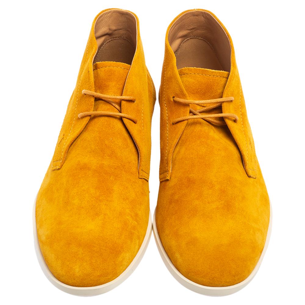 Aimed to elevate whatever you pair them with, these Tod's Desert boots come in a mustard yellow hue. The suede boots for men are secured with simple lace-ups and placed over rubber soles.

Includes: Original Dustbag, Original Box, Info card